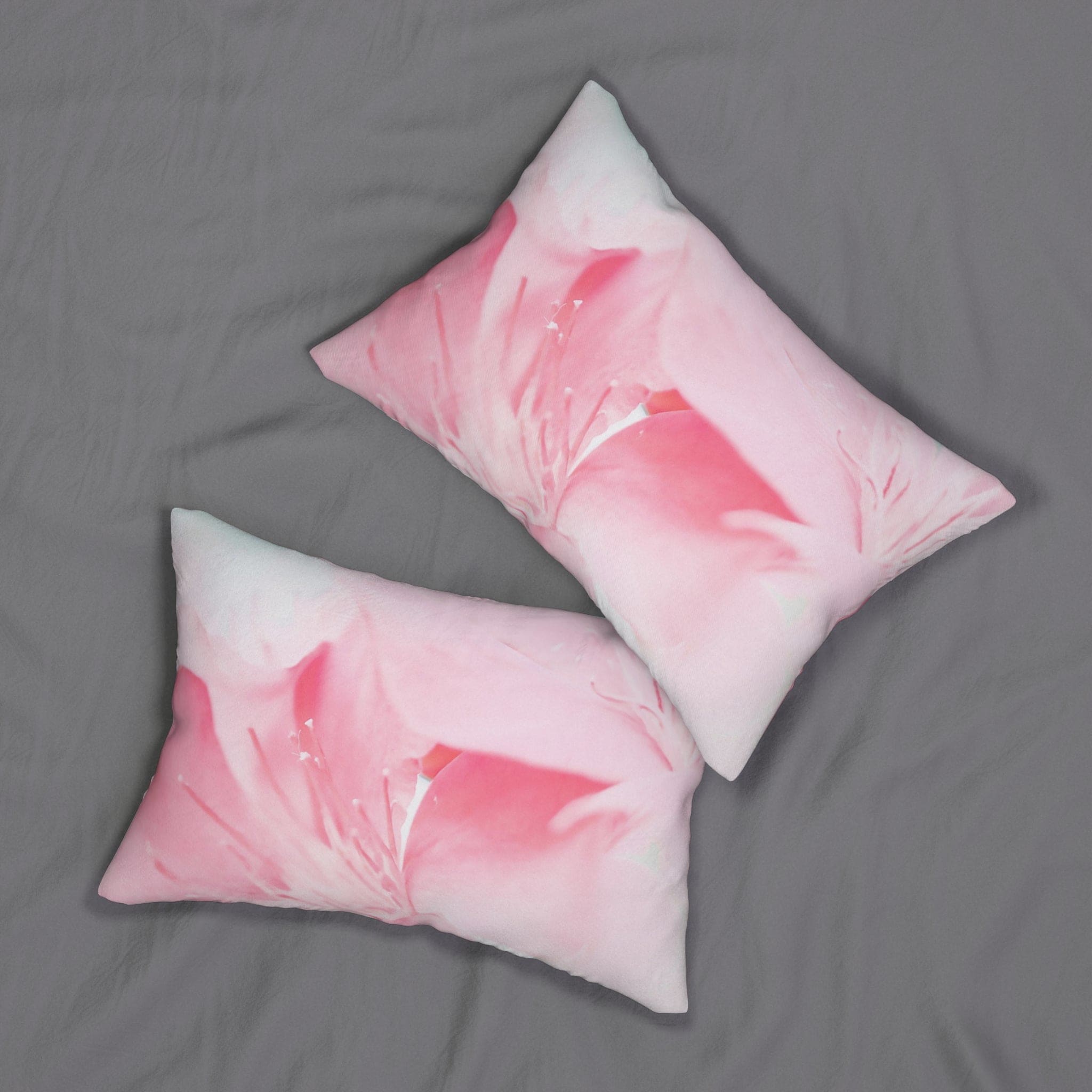 Decorative lumbar throw pillow featuring a vibrant pink flower bloom design, perfect for adding color and comfort to any living space.