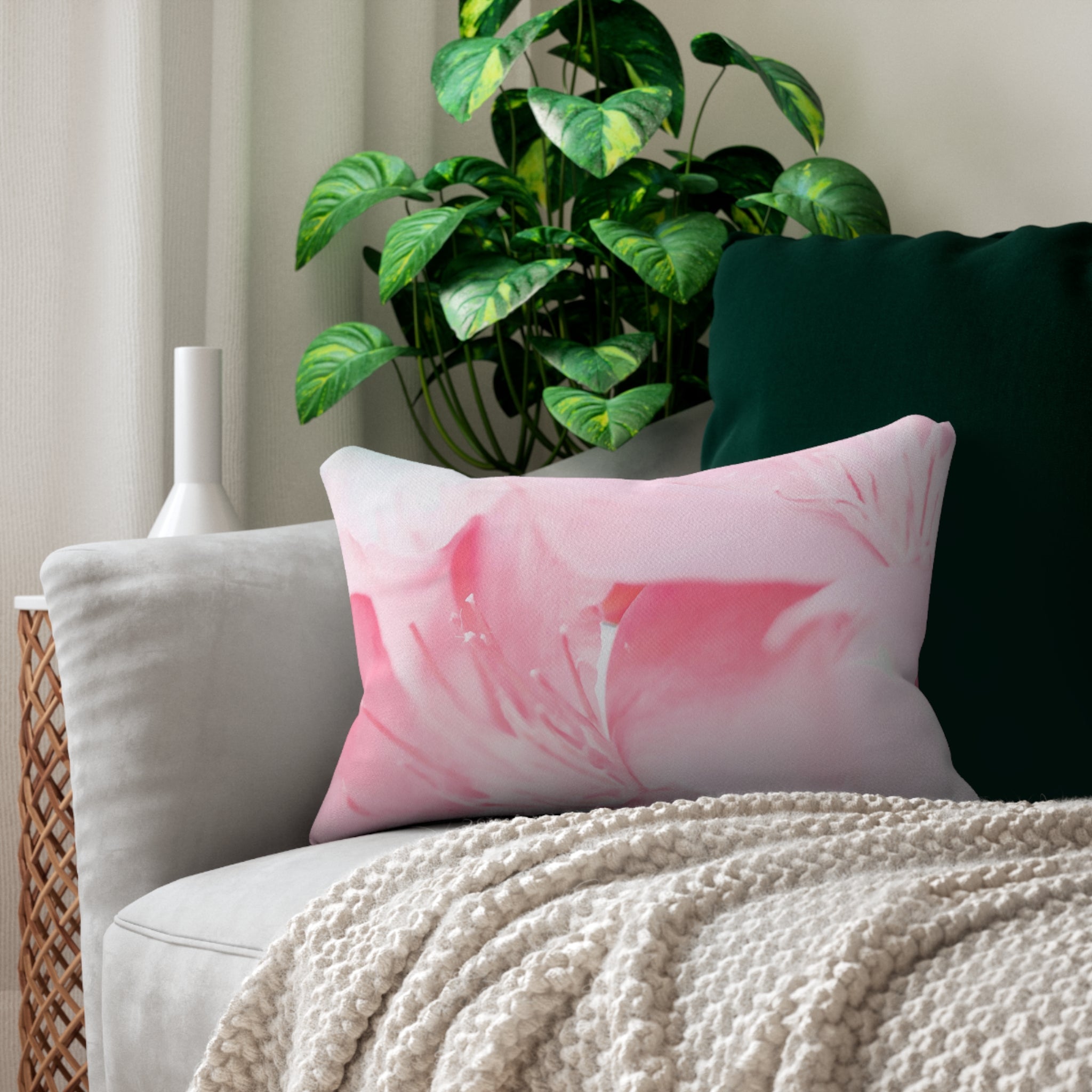 Decorative lumbar throw pillow featuring a vibrant pink flower bloom design, perfect for adding color and comfort to any living space.