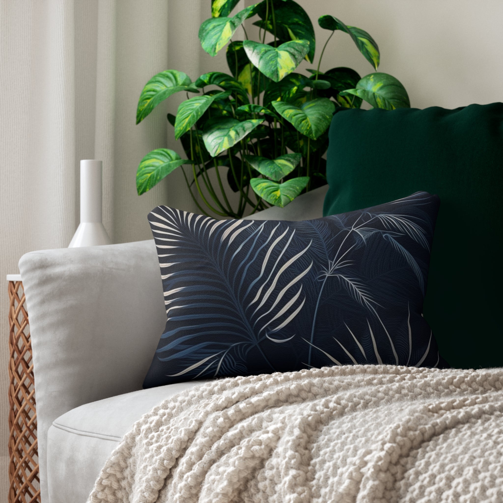 Couch with decorative pillow and plant.