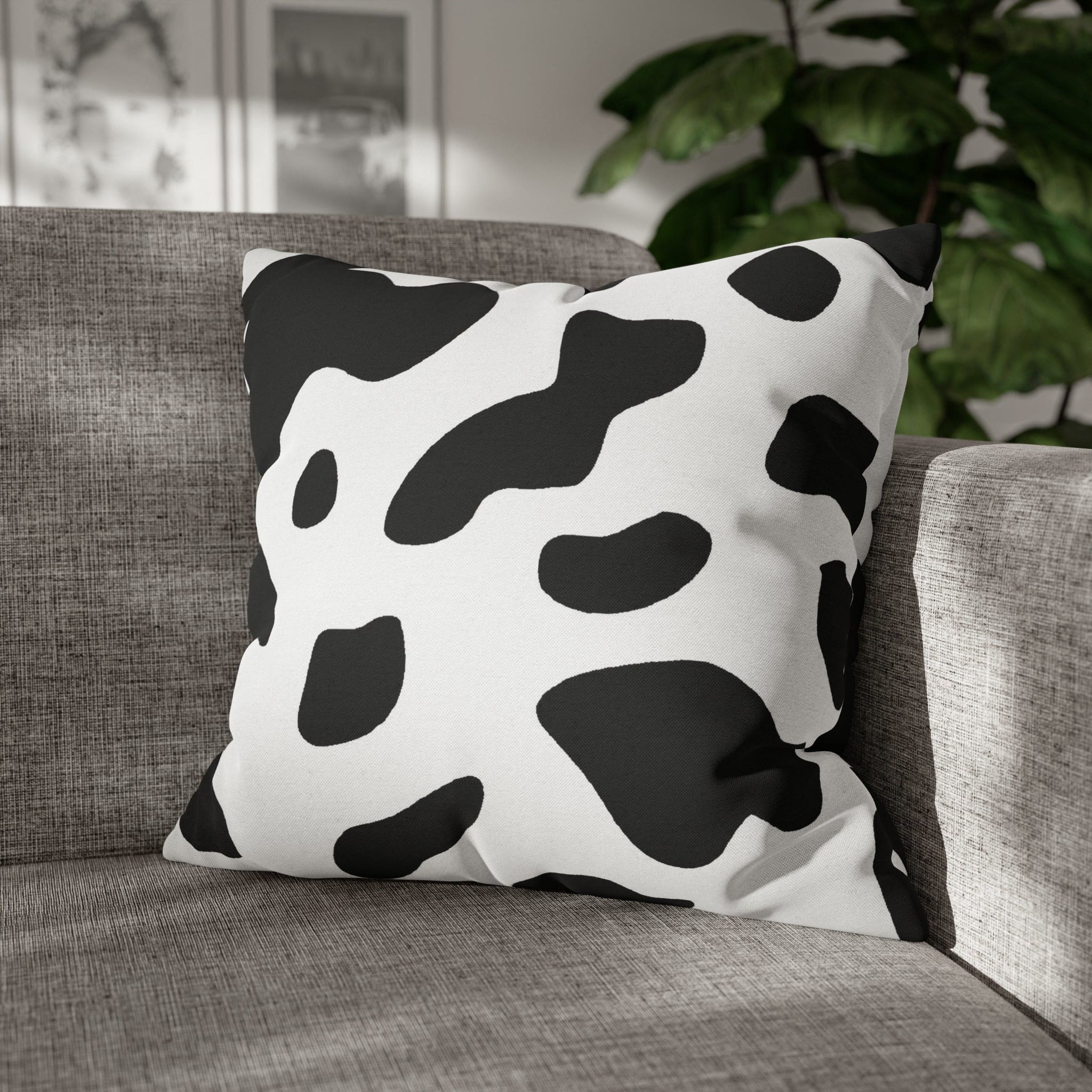 Decorative throw pillow cover featuring a black and white abstract cow print design, showcasing its stylish and modern aesthetic.