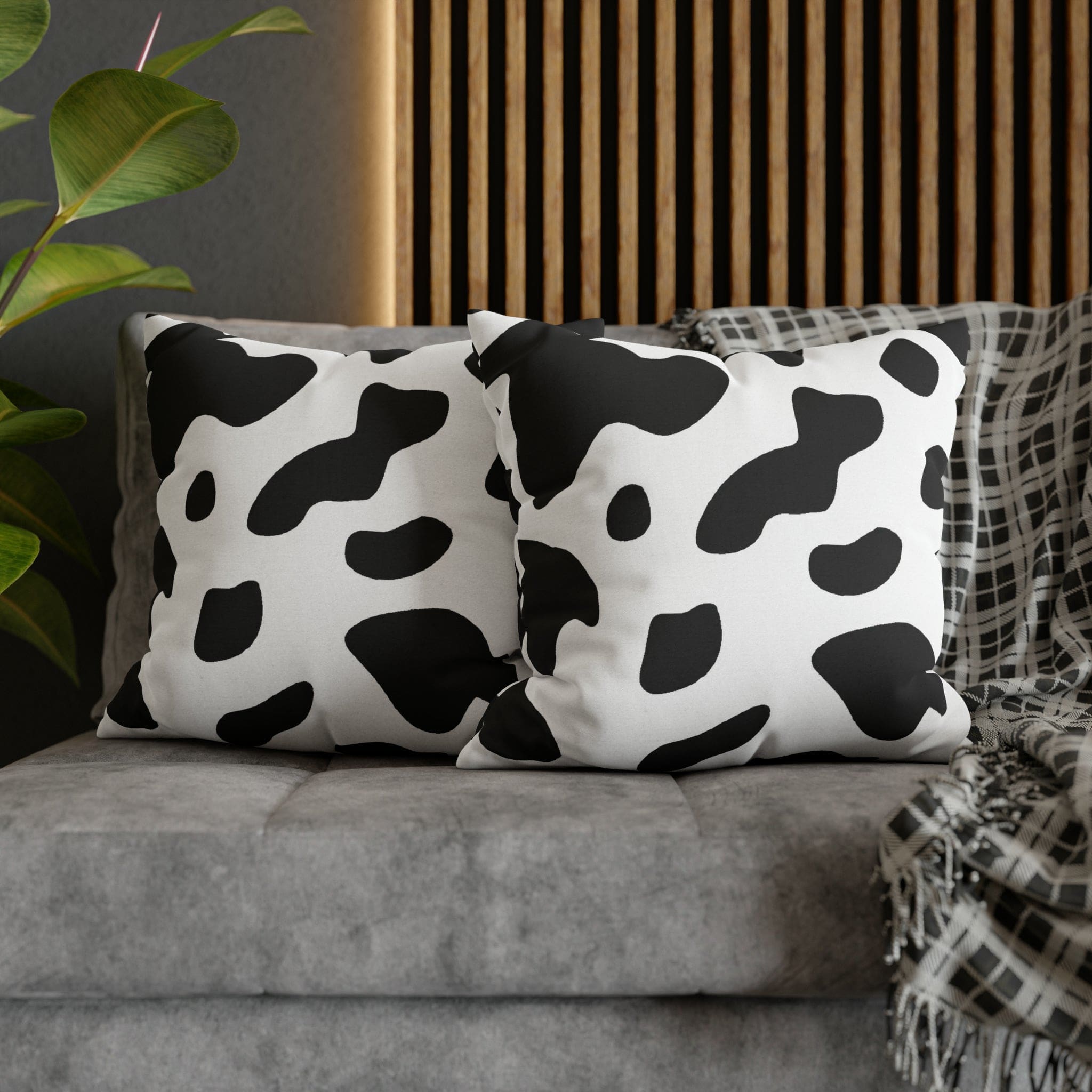 Decorative throw pillow cover featuring a black and white abstract cow print design, showcasing its stylish and modern aesthetic.