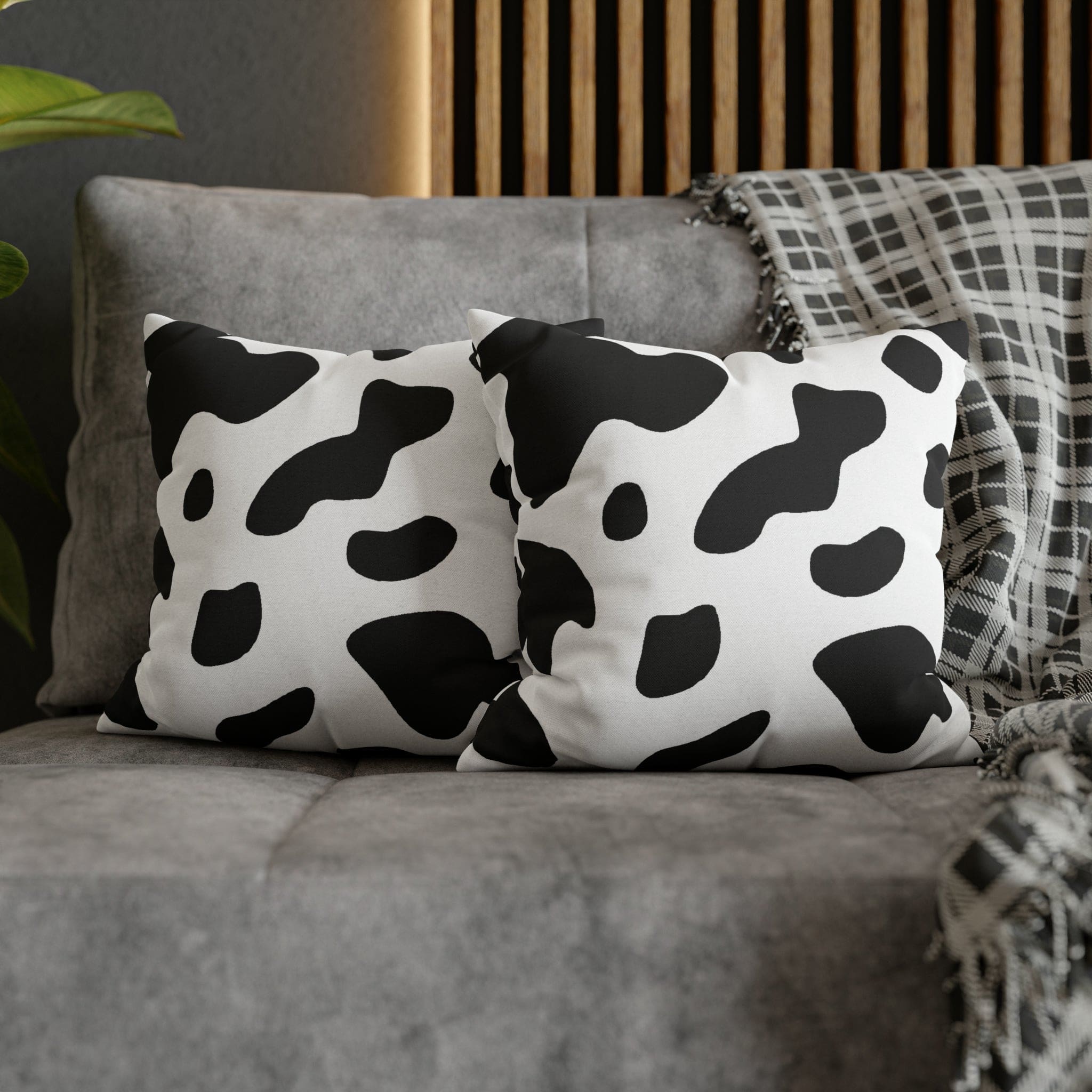 Decorative throw pillow cover featuring a black and white abstract cow print design, showcasing its stylish and modern aesthetic.