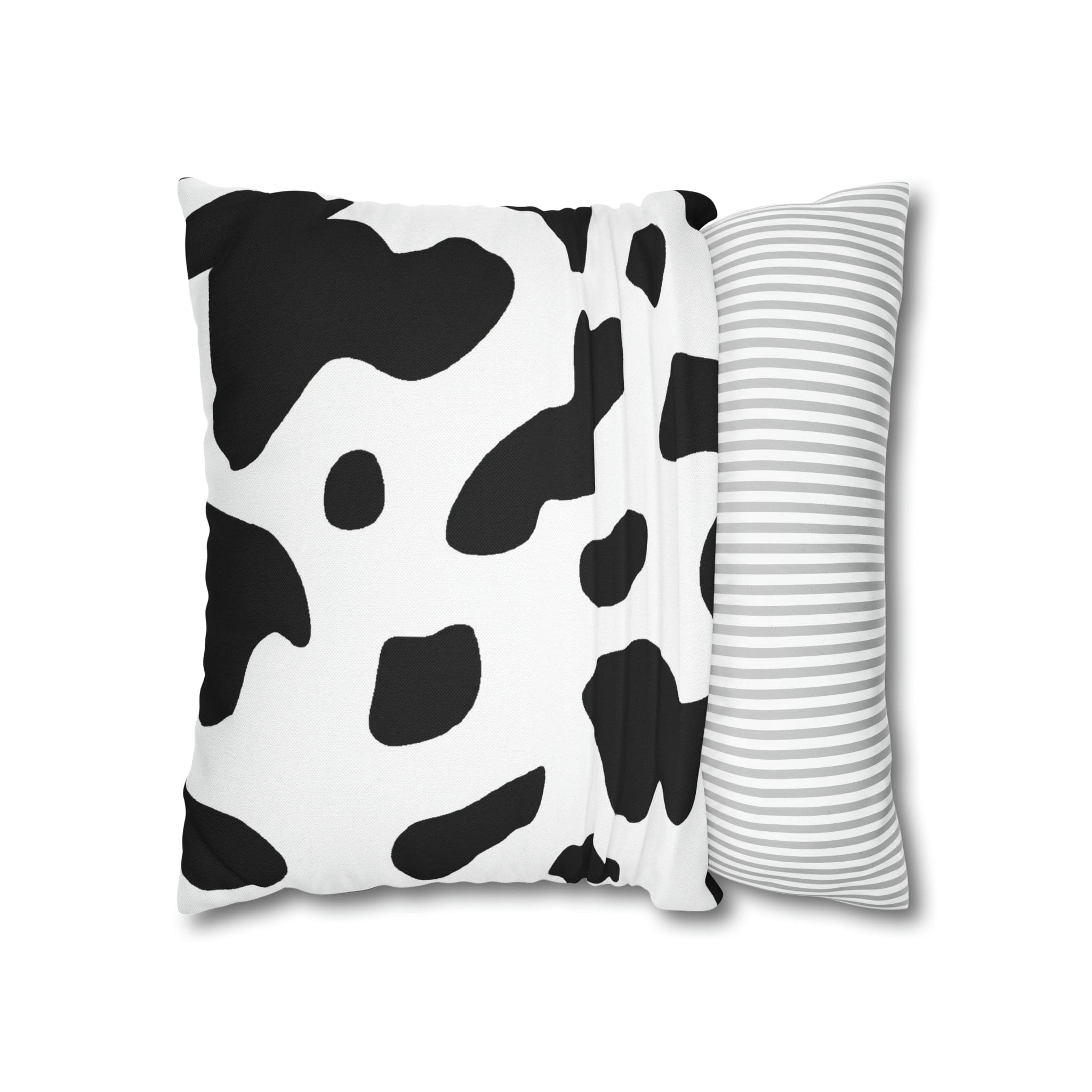 Decorative throw pillow cover featuring a black and white abstract cow print design, showcasing its stylish and modern aesthetic.