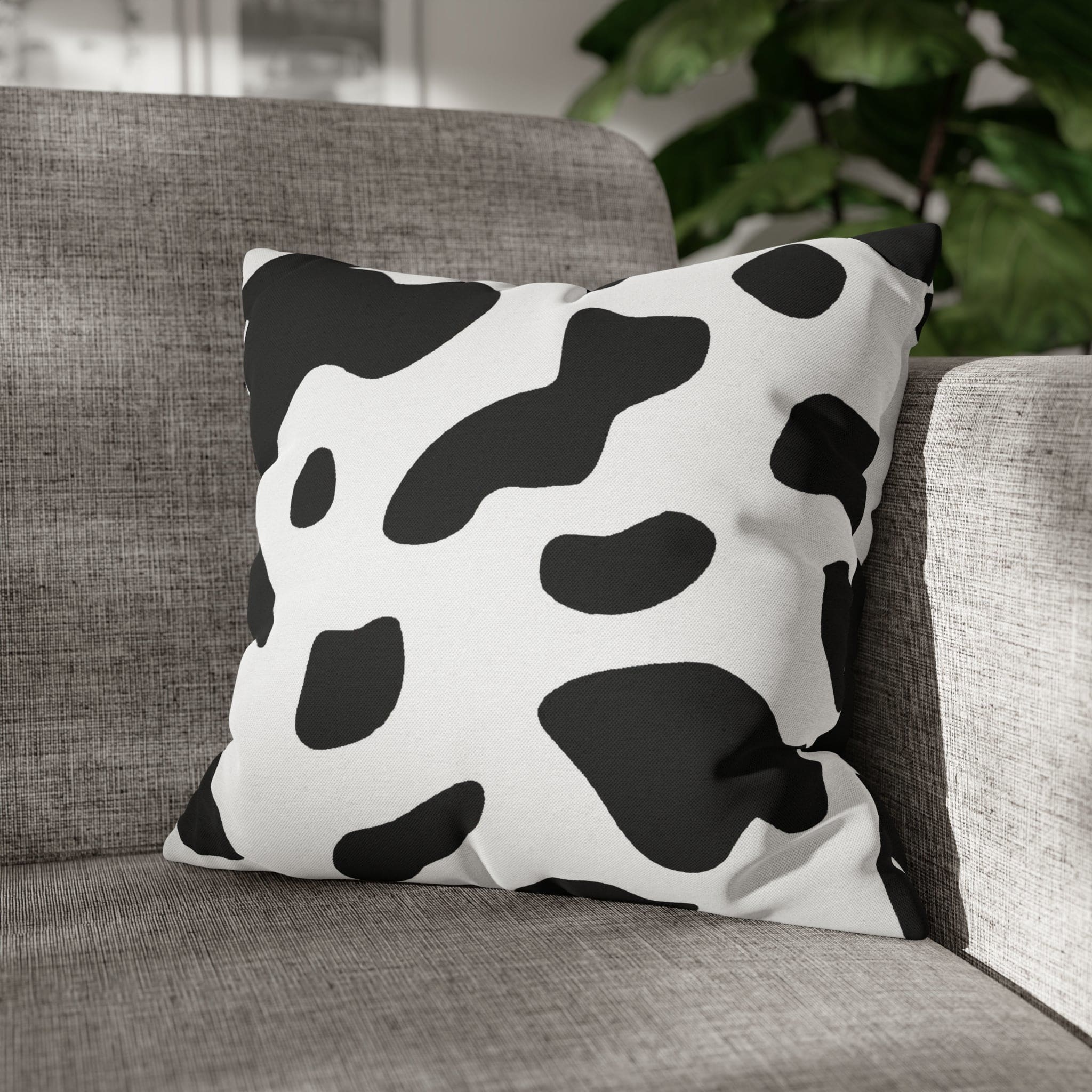 Decorative throw pillow cover featuring a black and white abstract cow print design, showcasing its stylish and modern aesthetic.