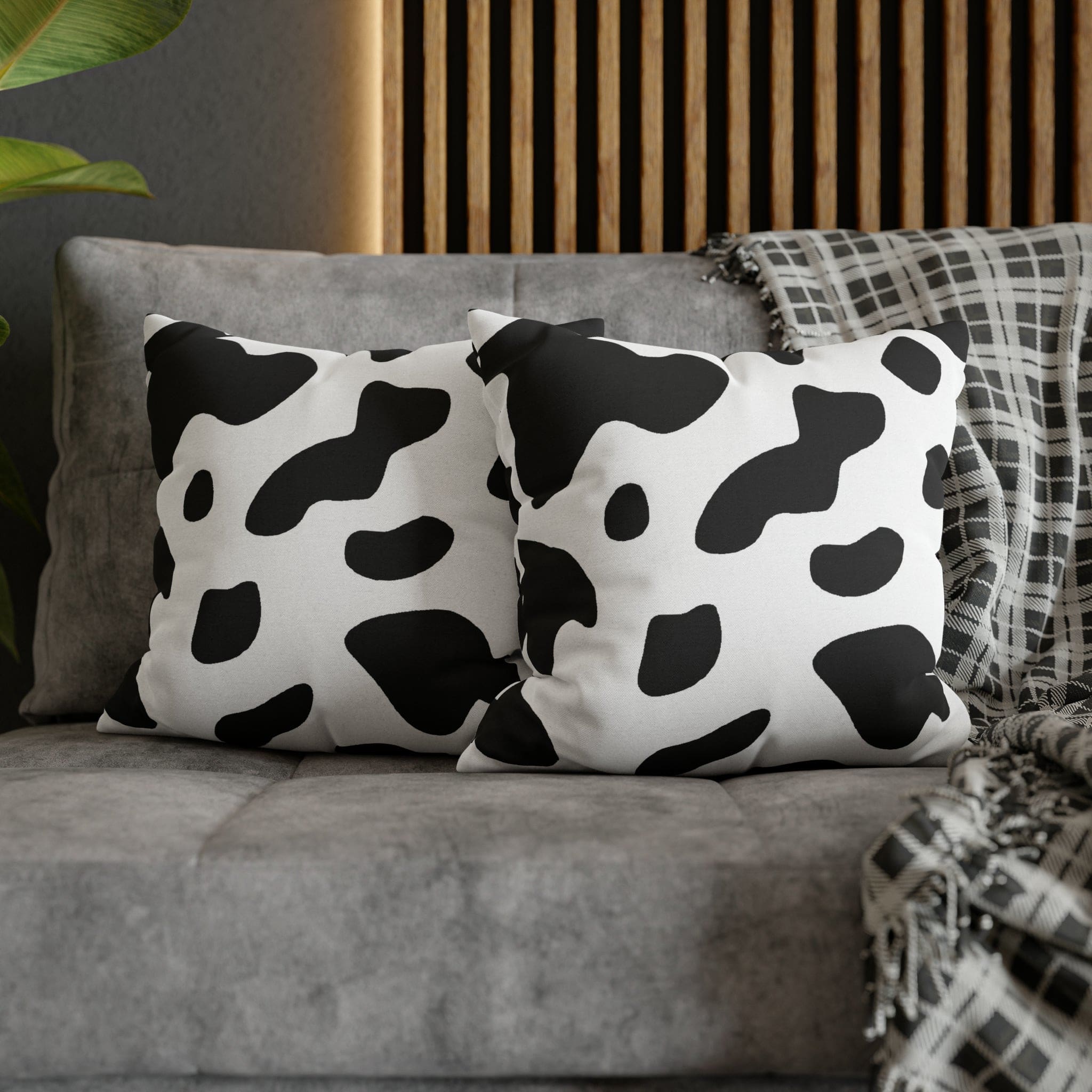 Decorative throw pillow cover featuring a black and white abstract cow print design, showcasing its stylish and modern aesthetic.