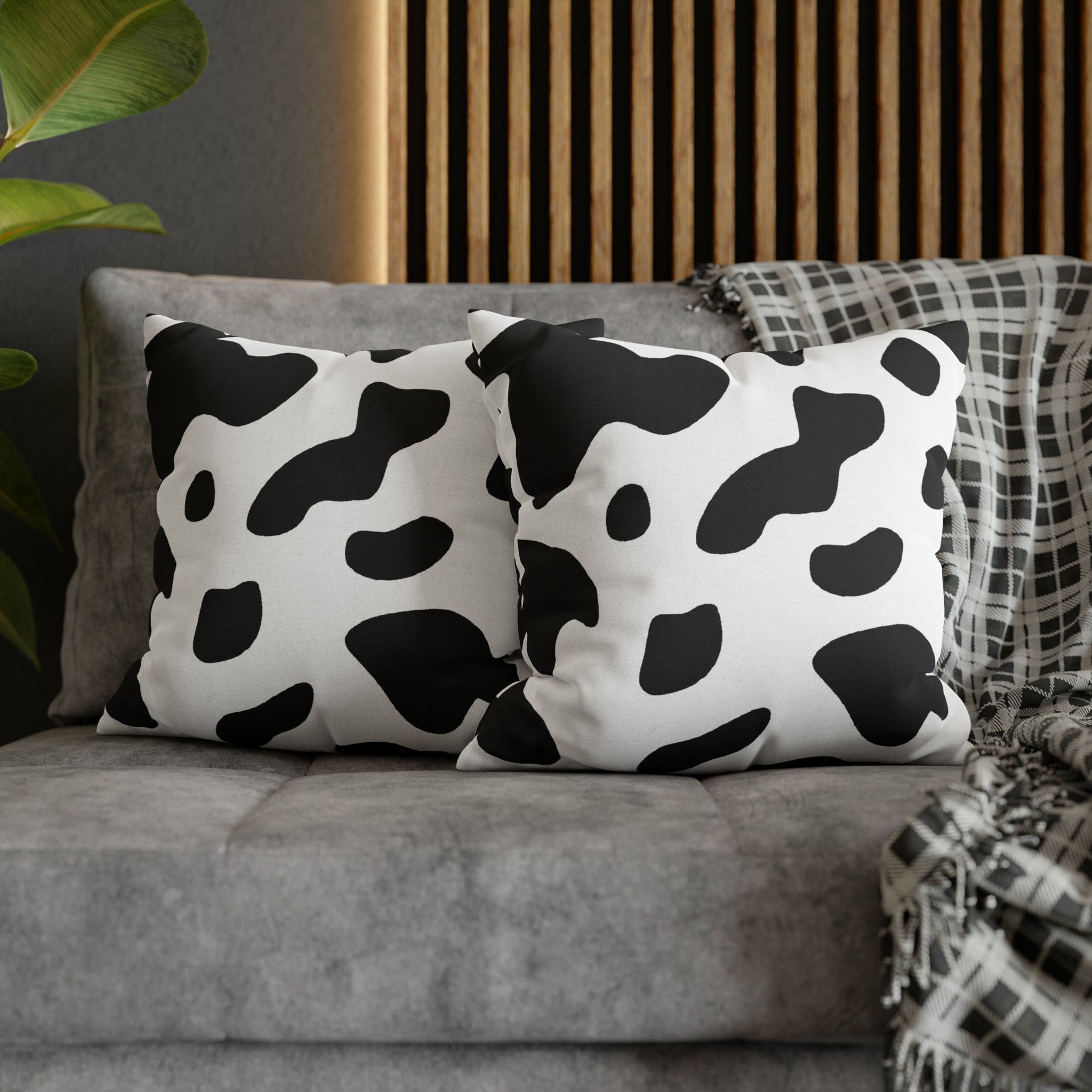 Decorative throw pillow cover featuring a black and white abstract cow print design, showcasing its stylish and modern aesthetic.