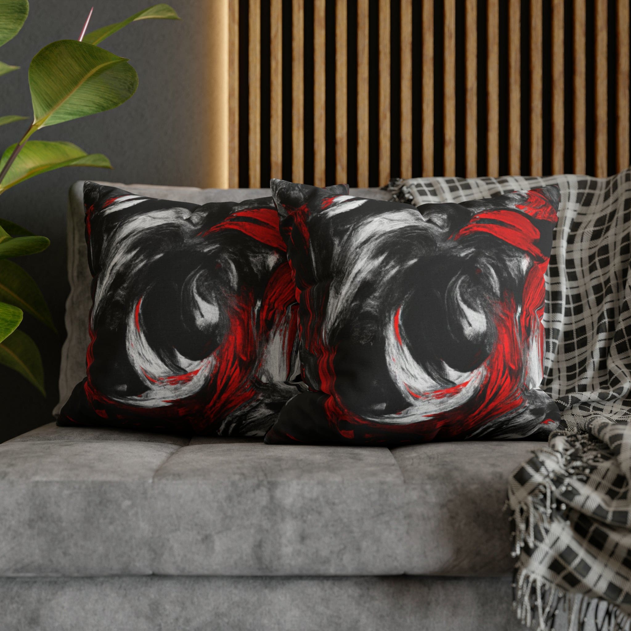 Decorative throw pillow cover featuring a black, red, and white abstract pattern, ideal for enhancing home decor.