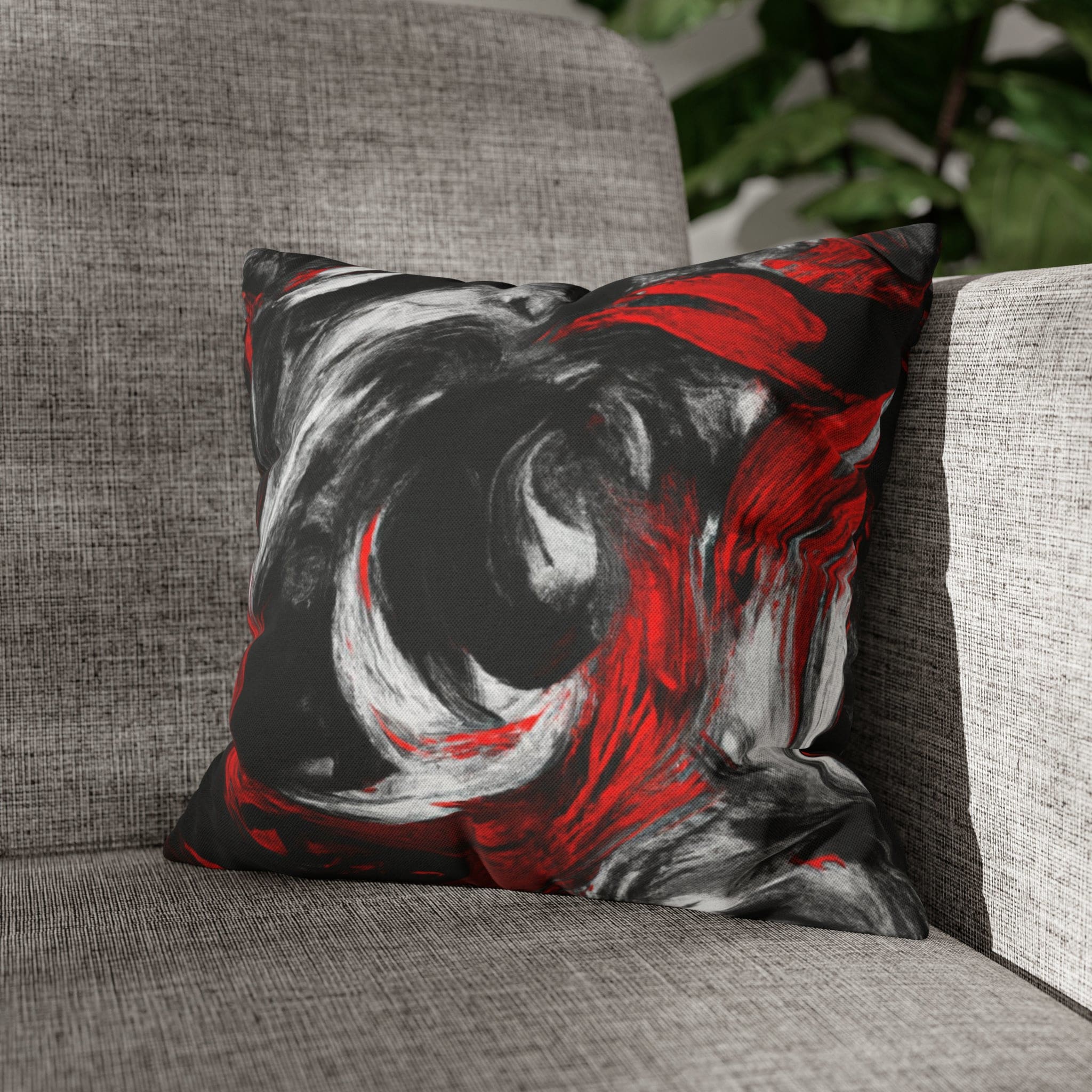 Decorative throw pillow cover featuring a black, red, and white abstract pattern, ideal for enhancing home decor.