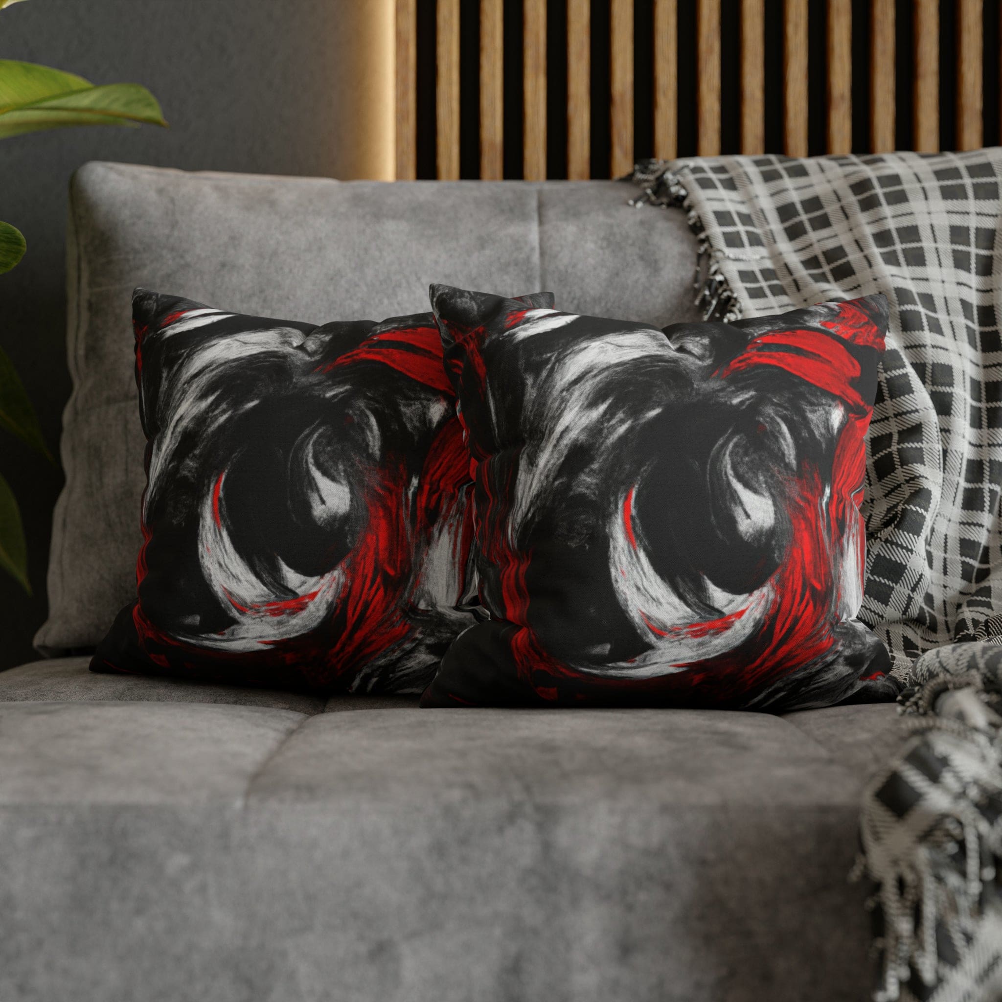 Decorative throw pillow cover featuring a black, red, and white abstract pattern, ideal for enhancing home decor.