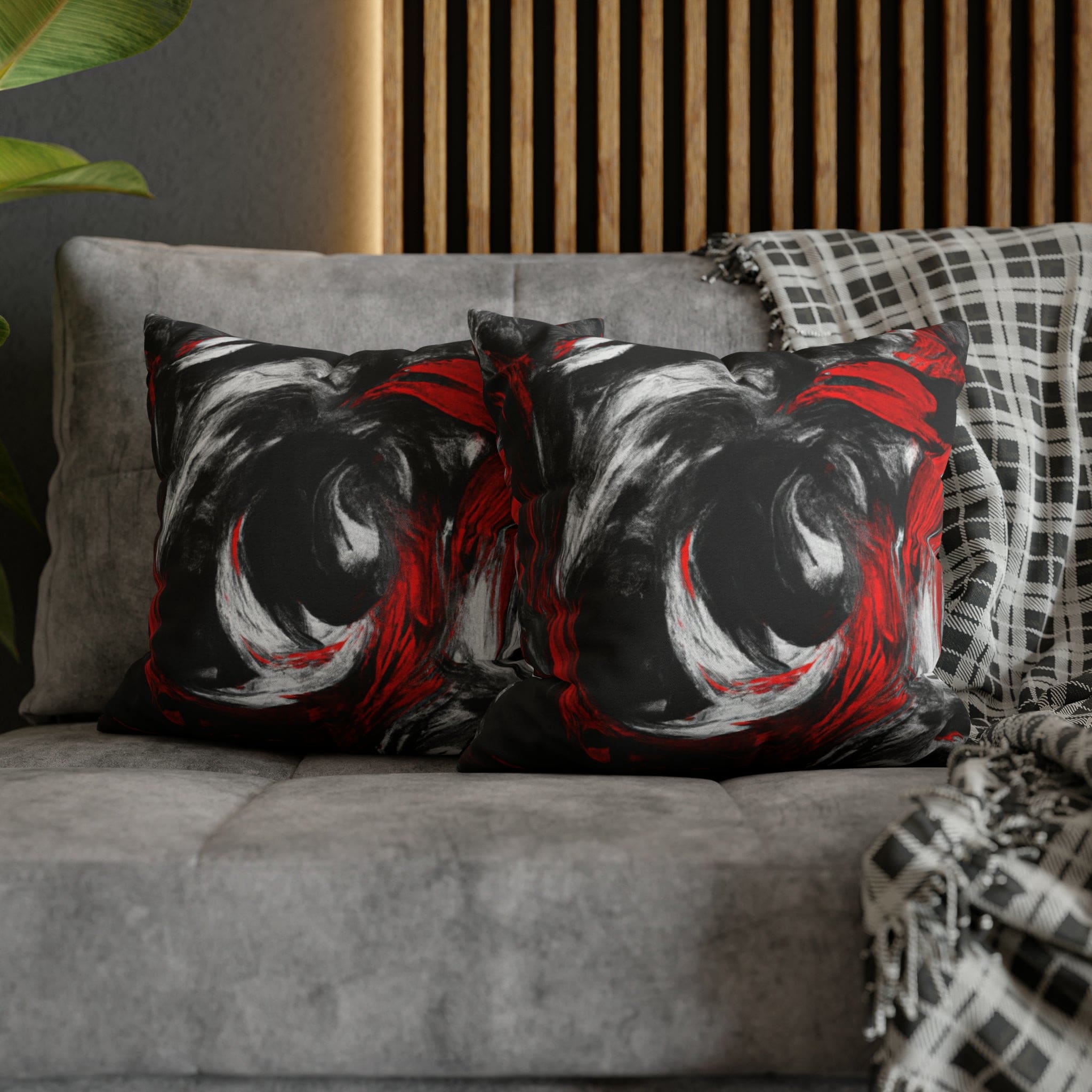 Decorative throw pillow cover featuring a black, red, and white abstract pattern, ideal for enhancing home decor.