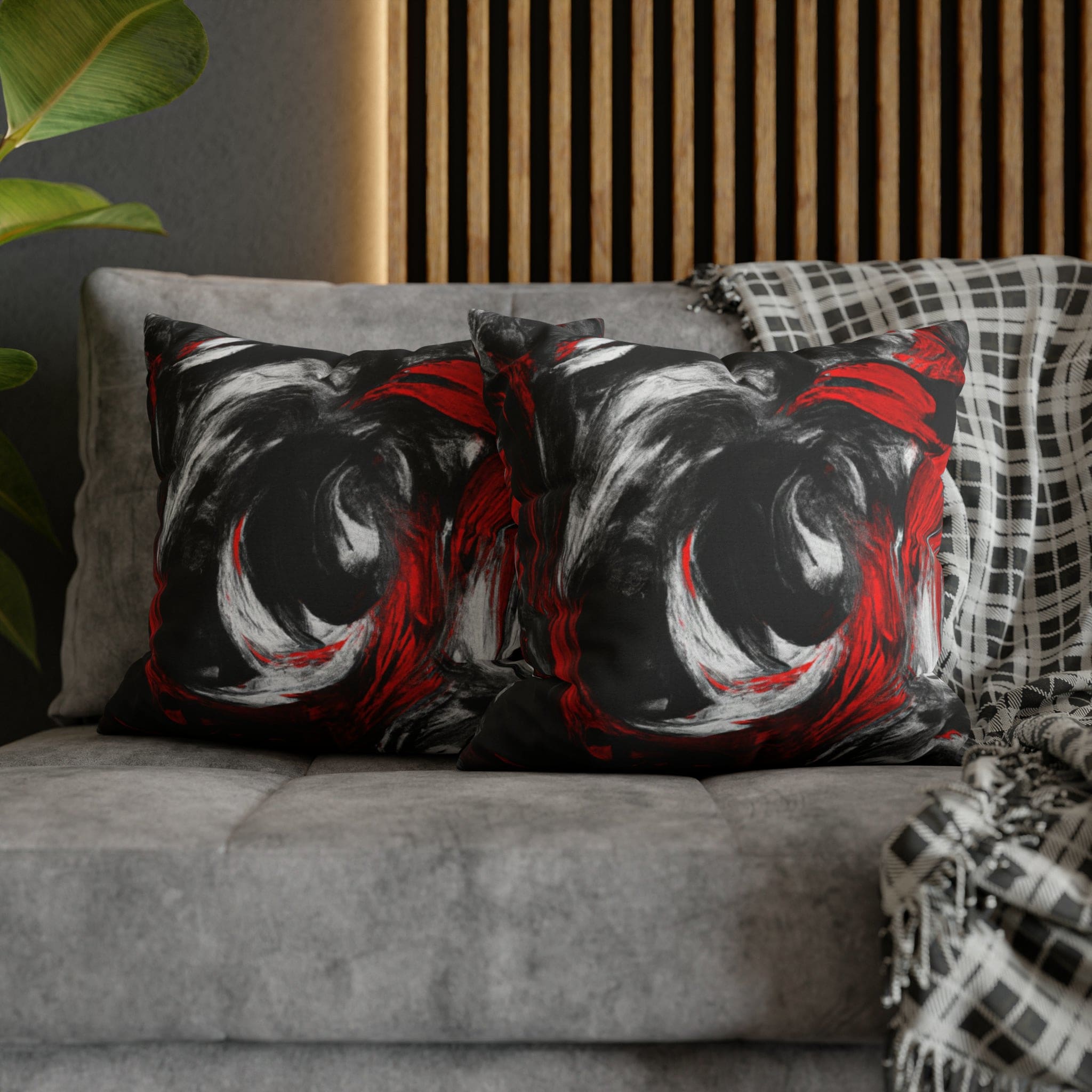 Decorative throw pillow cover featuring a black, red, and white abstract pattern, ideal for enhancing home decor.