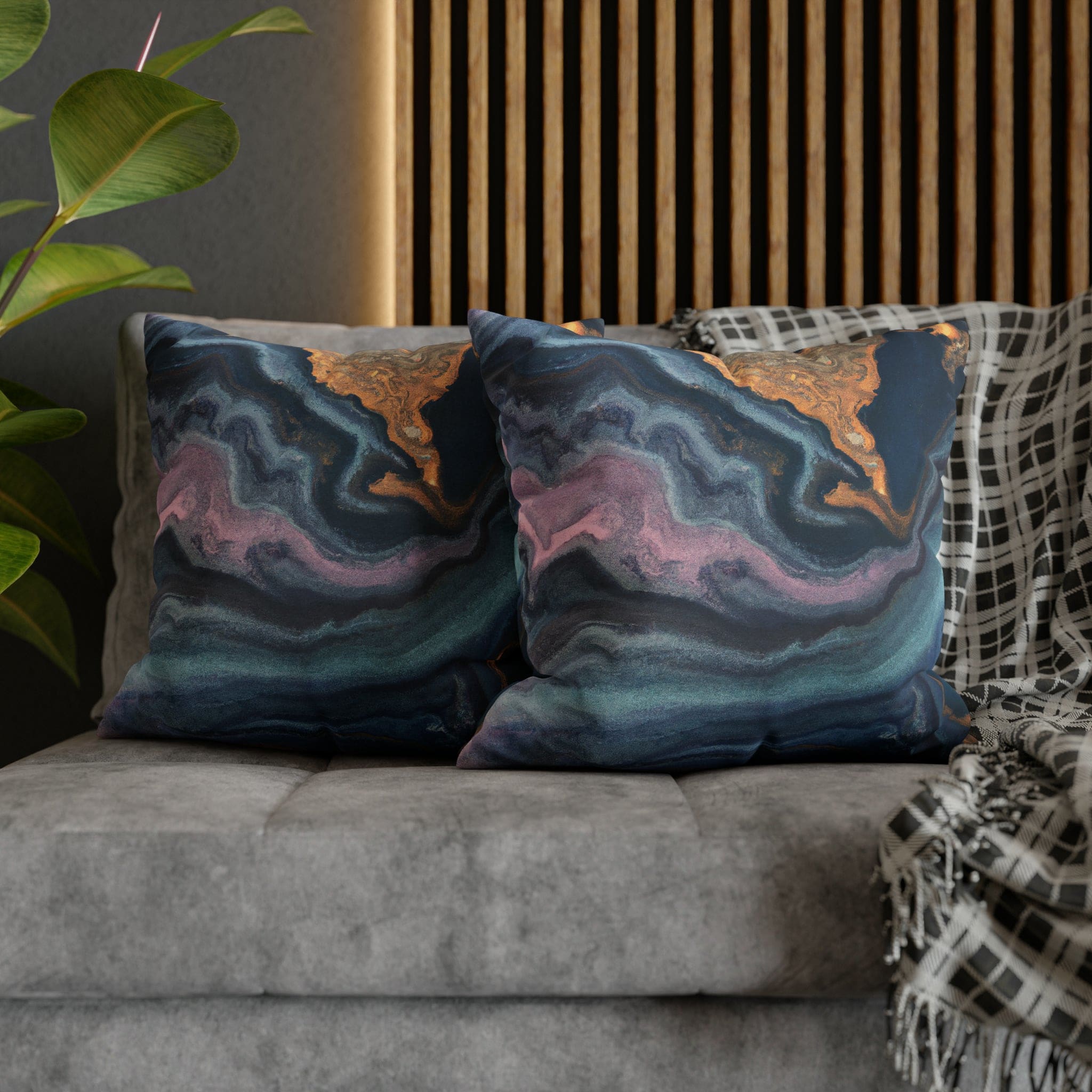 Decorative throw pillow cover featuring a blue, pink, and gold marble swirl pattern, showcasing vibrant colors and a luxurious design.