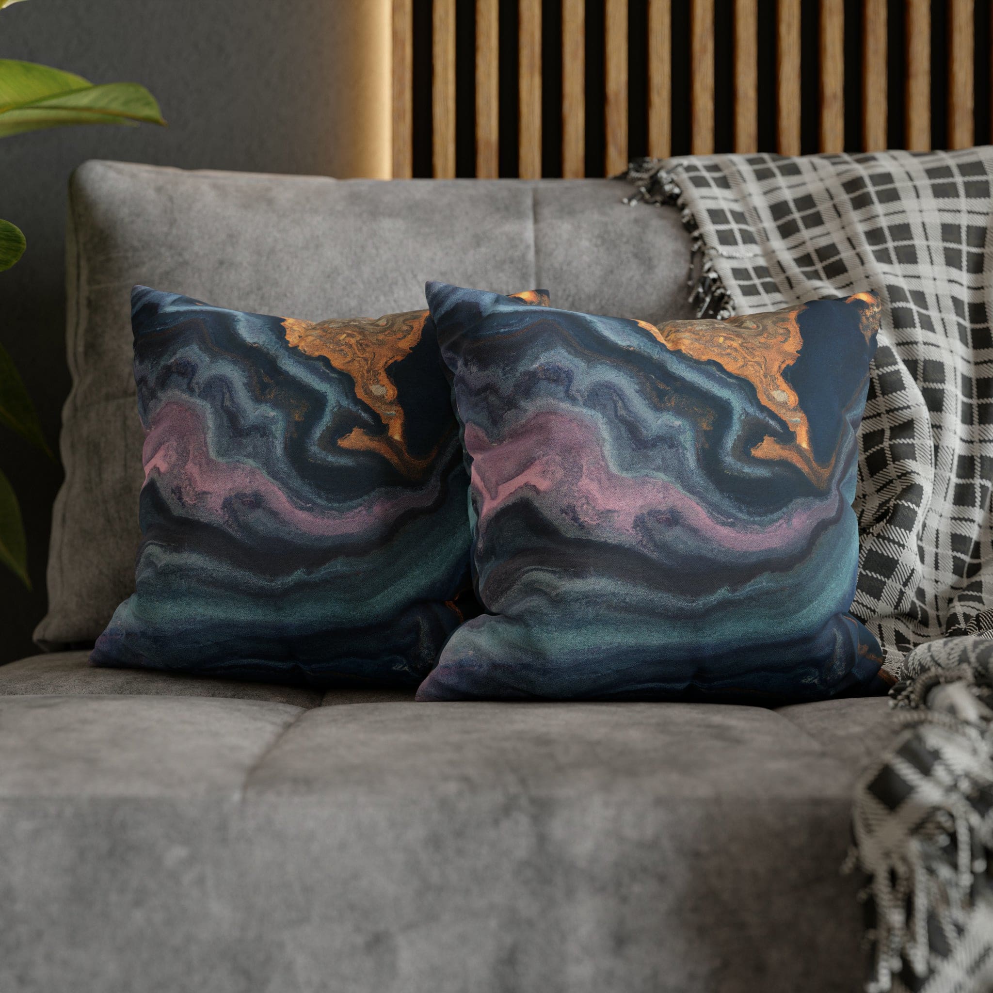 Decorative throw pillow cover featuring a blue, pink, and gold marble swirl pattern, showcasing vibrant colors and a luxurious design.