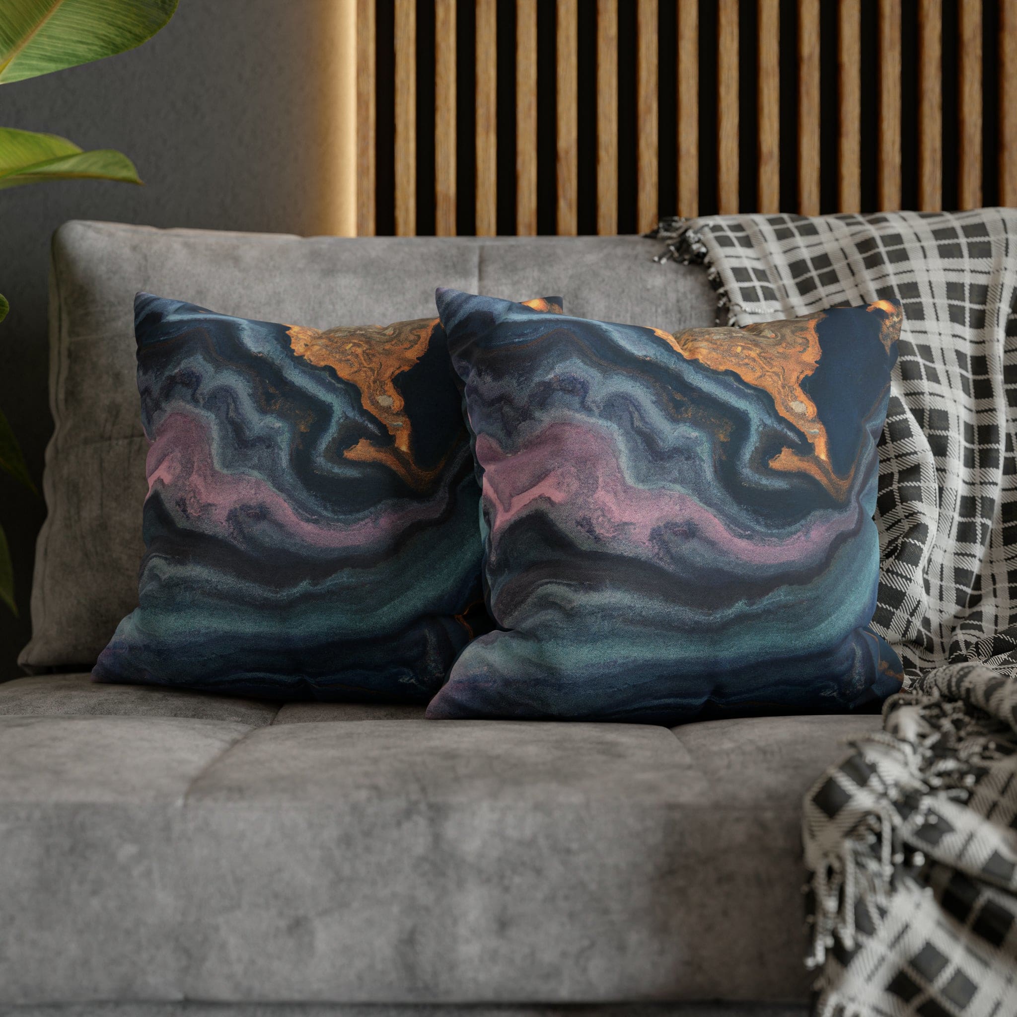 Decorative throw pillow cover featuring a blue, pink, and gold marble swirl pattern, showcasing vibrant colors and a luxurious design.