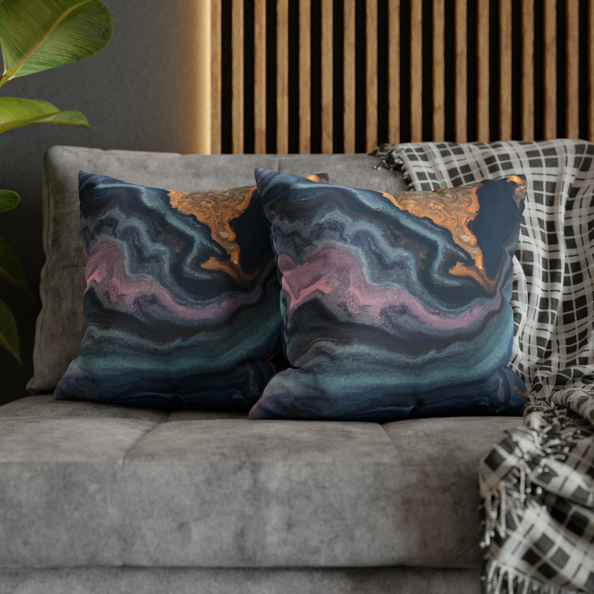 Decorative throw pillow cover featuring a blue, pink, and gold marble swirl pattern, showcasing vibrant colors and a luxurious design.