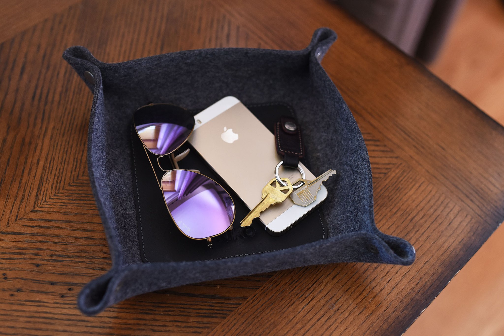 Chic Desk Tray made of soft grey wool felt and leather, designed to organize essentials like keys and phone.