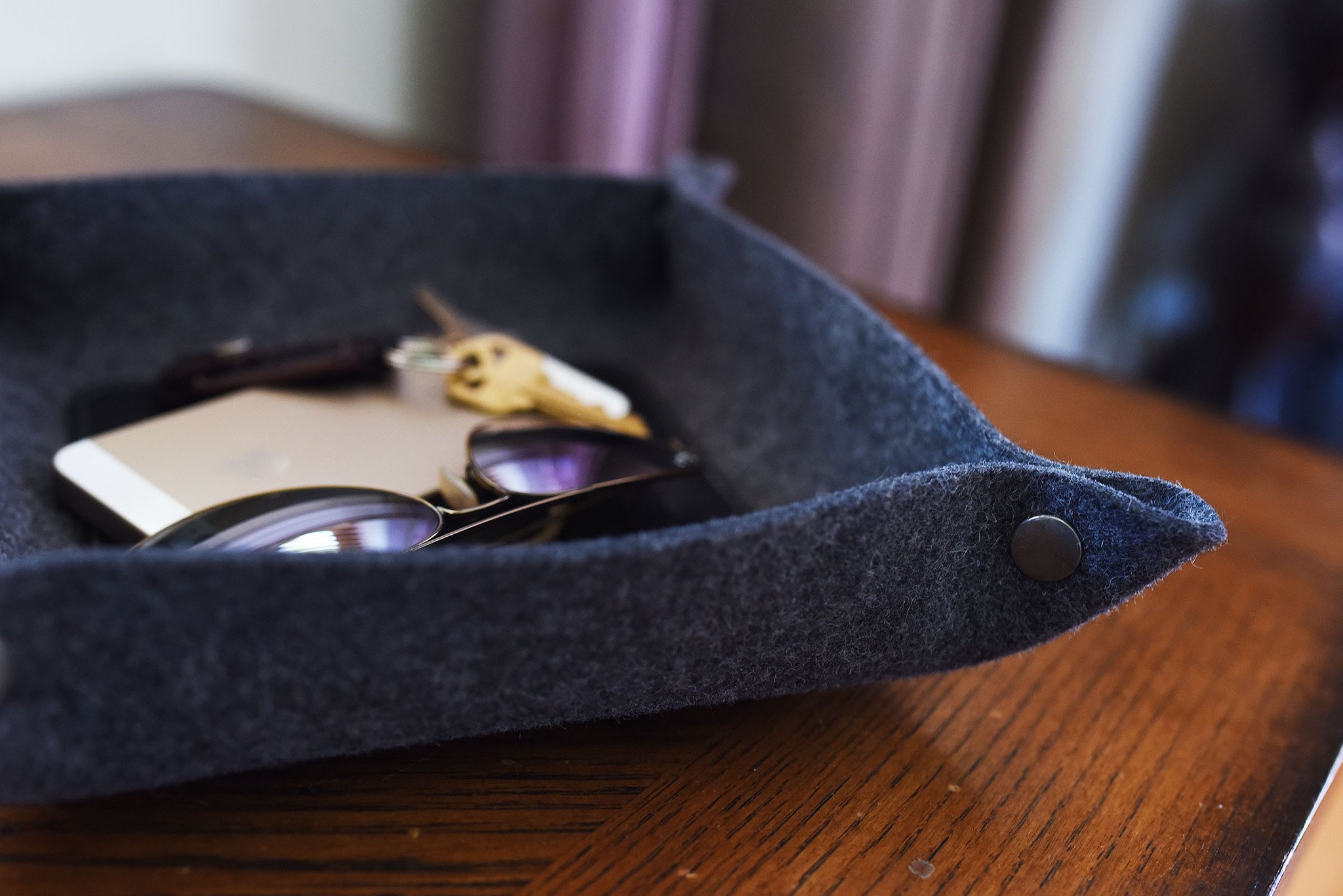 Chic Desk Tray made of soft grey wool felt and leather, designed to organize essentials like keys and phone.