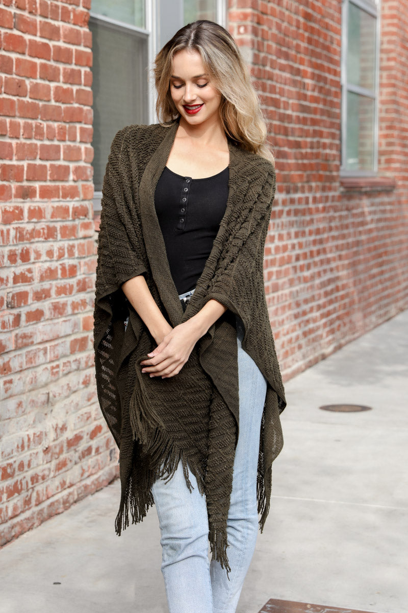 A stylish Diagonal Knit Tasseled Ruana featuring a unique diagonal knit pattern and playful tassels, perfect for any occasion.