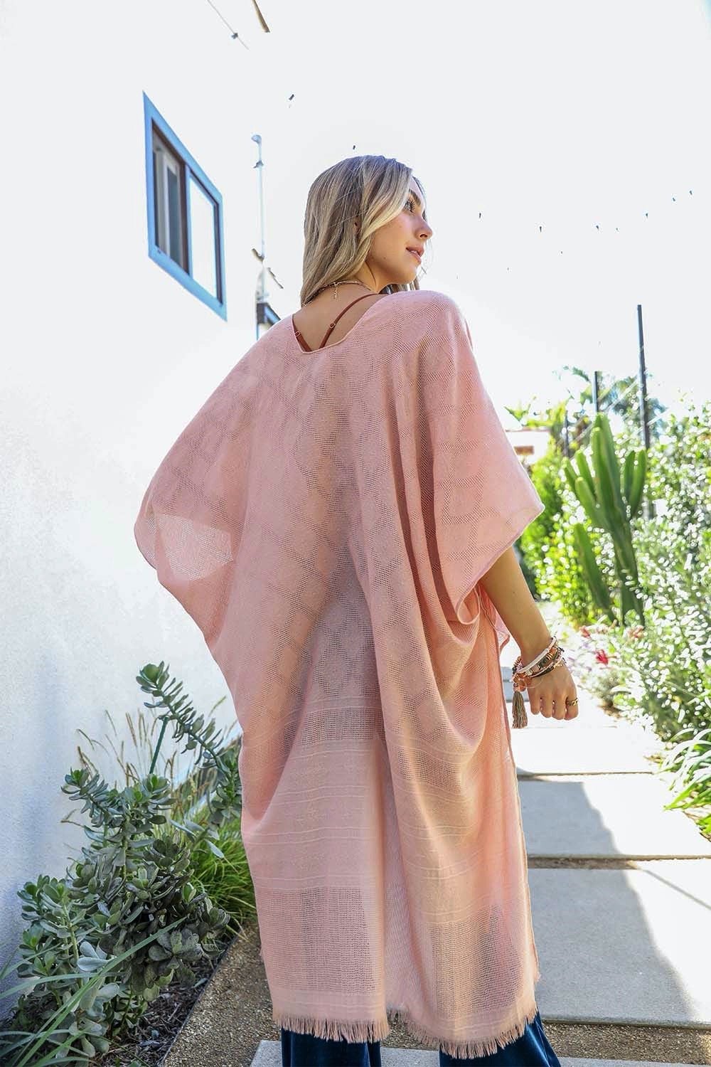 A stylish diamond embroidered kimono featuring frayed edges, perfect for a feminine and trendy look.