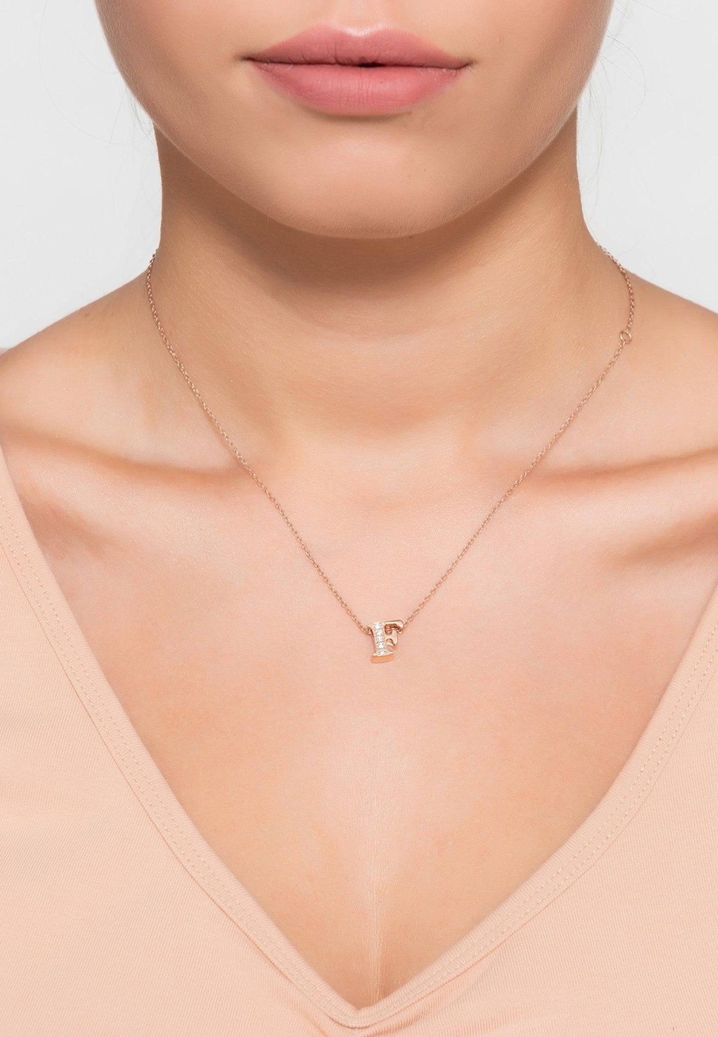 Rose gold initial letter pendant necklace adorned with diamonds, elegantly crafted from sterling silver.