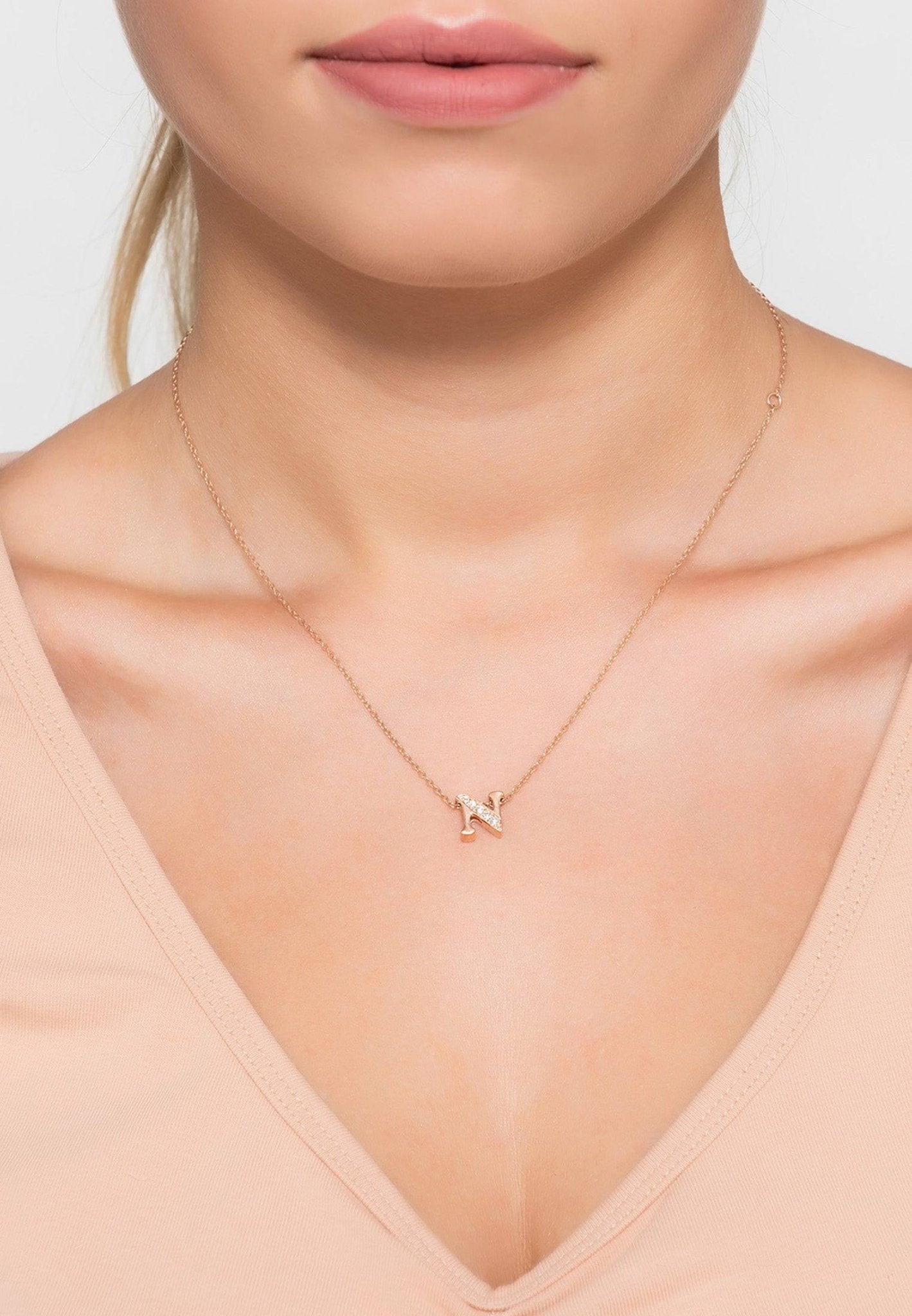 Rose gold initial letter pendant necklace adorned with sparkling diamonds, elegantly crafted from sterling silver.