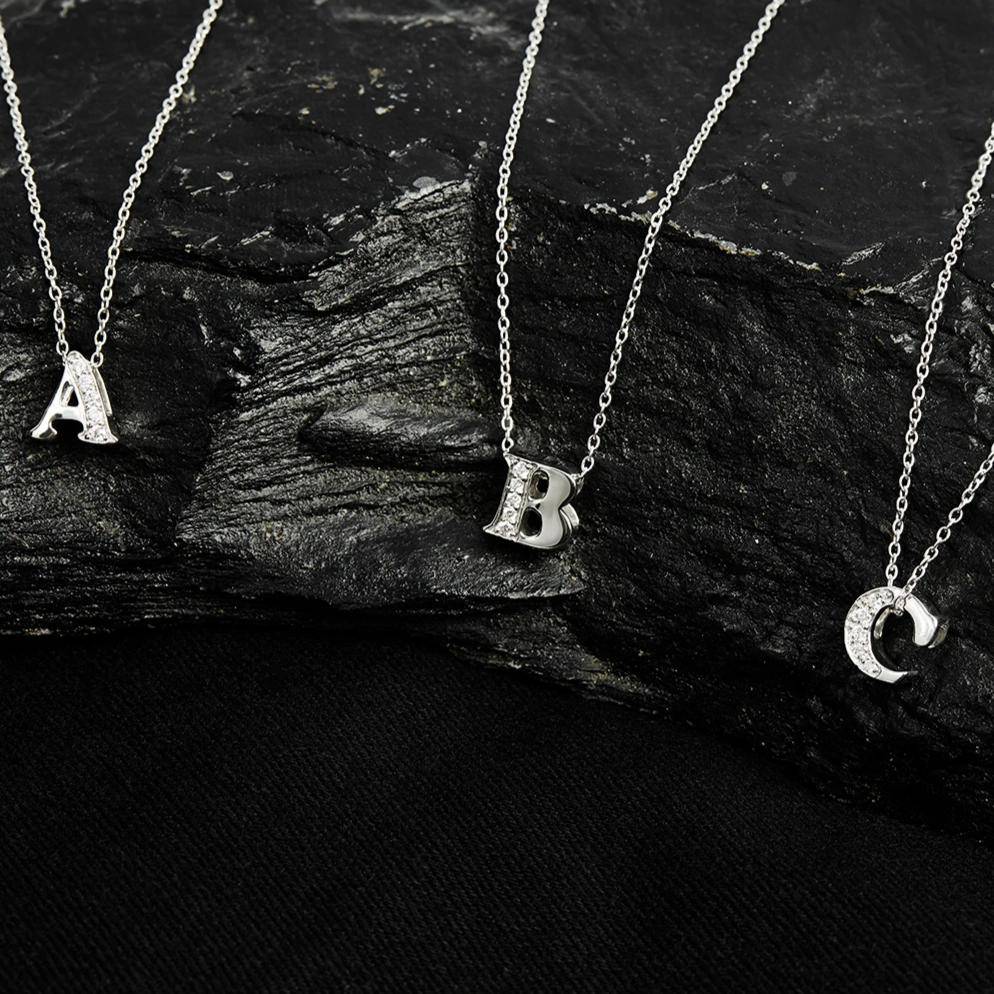 Diamond Initial Letter Pendant Necklace in Silver featuring the letter O, adorned with brilliant cut diamonds, elegantly displayed in a jewelry box.