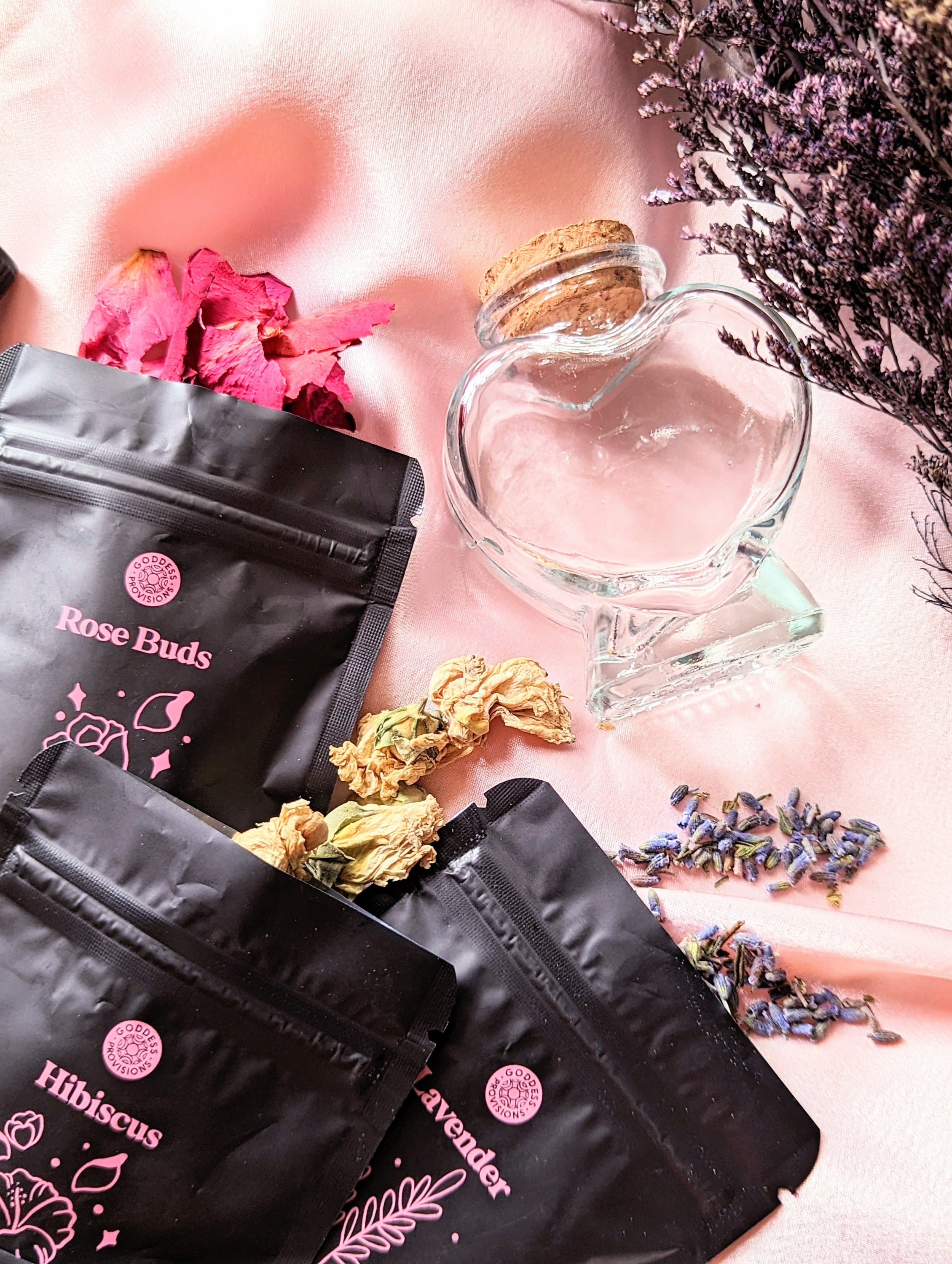 Divine Love Ritual Kit by Goddess Provisions featuring dried flowers, rose quartz, and a heart-shaped jar.