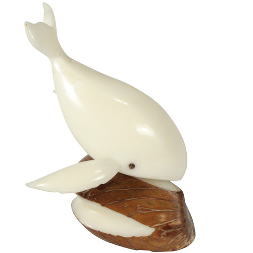 A hand-carved Diving Whale figurine made from tagua nuts, showcasing its intricate details and natural colors.