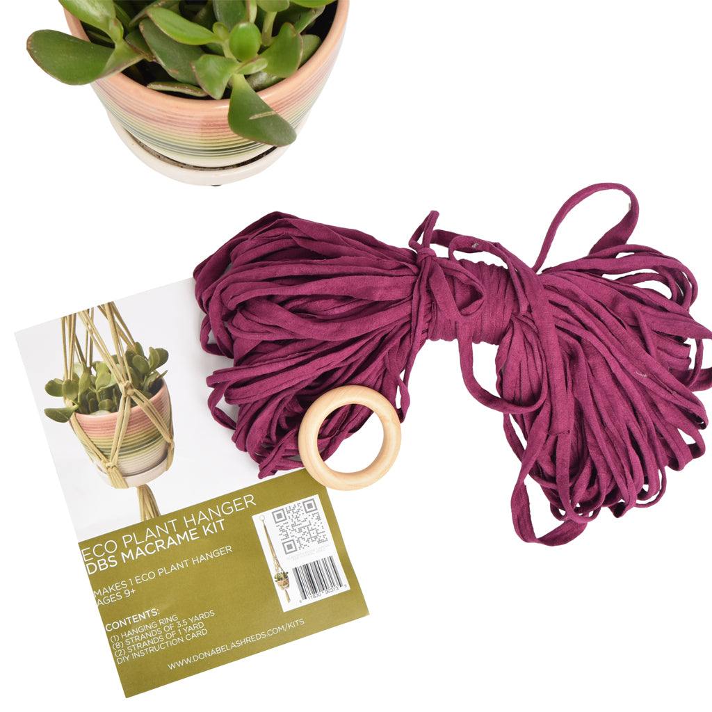 DIY Eco Macramé Plant Hanger Kit with eco-friendly materials and colorful cords displayed on a wooden surface.