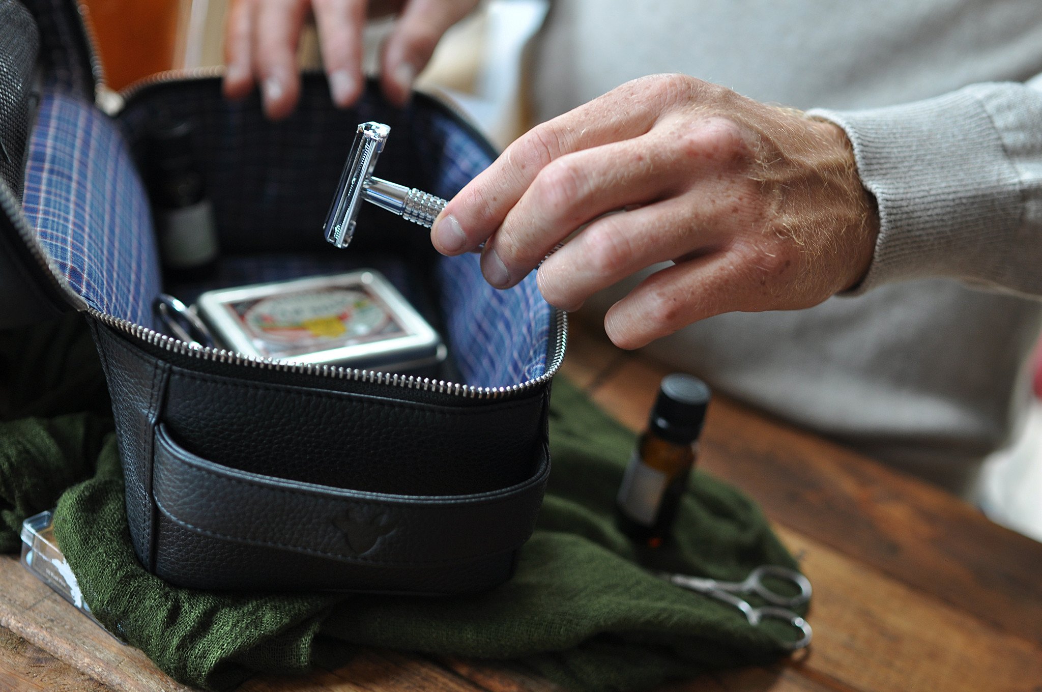 Elegant Dopp Kit made from premium leather with a carrying handle and zipped netted storage area.