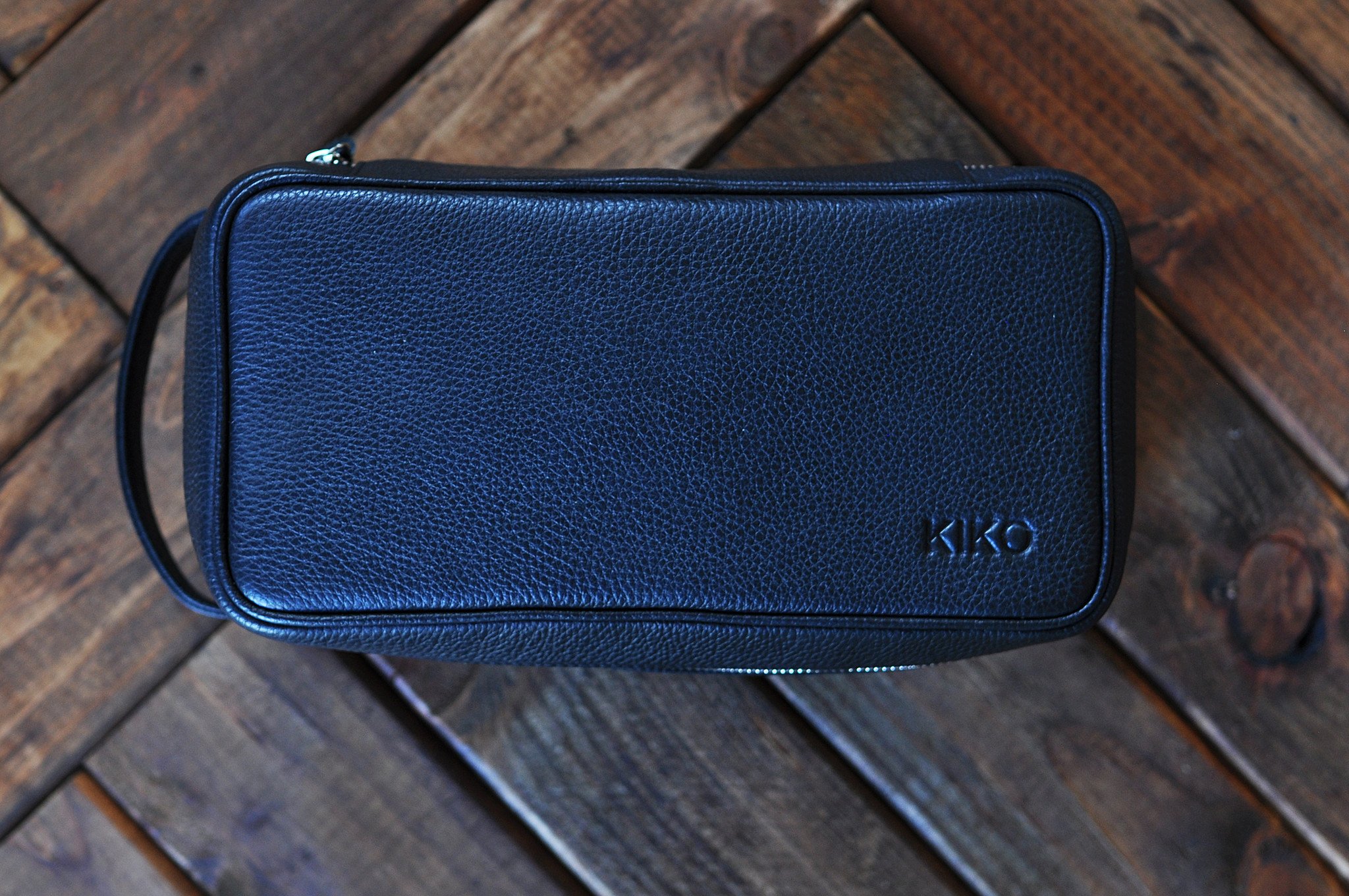 Elegant Dopp Kit made from premium leather with a carrying handle and zipped netted storage area.