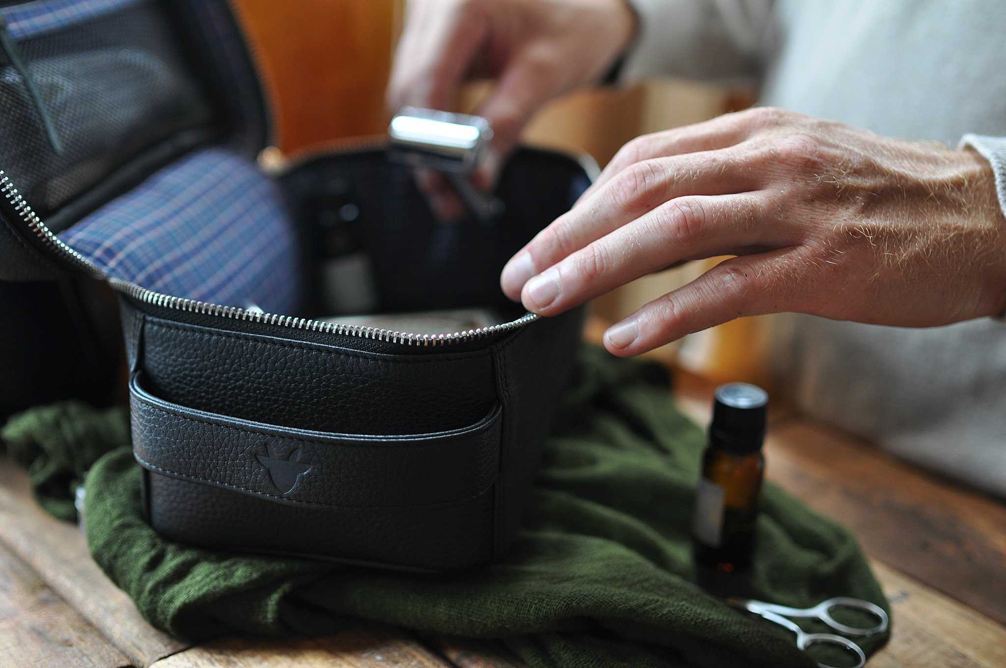 Elegant Dopp Kit made from premium leather with a carrying handle and zipped netted storage area.