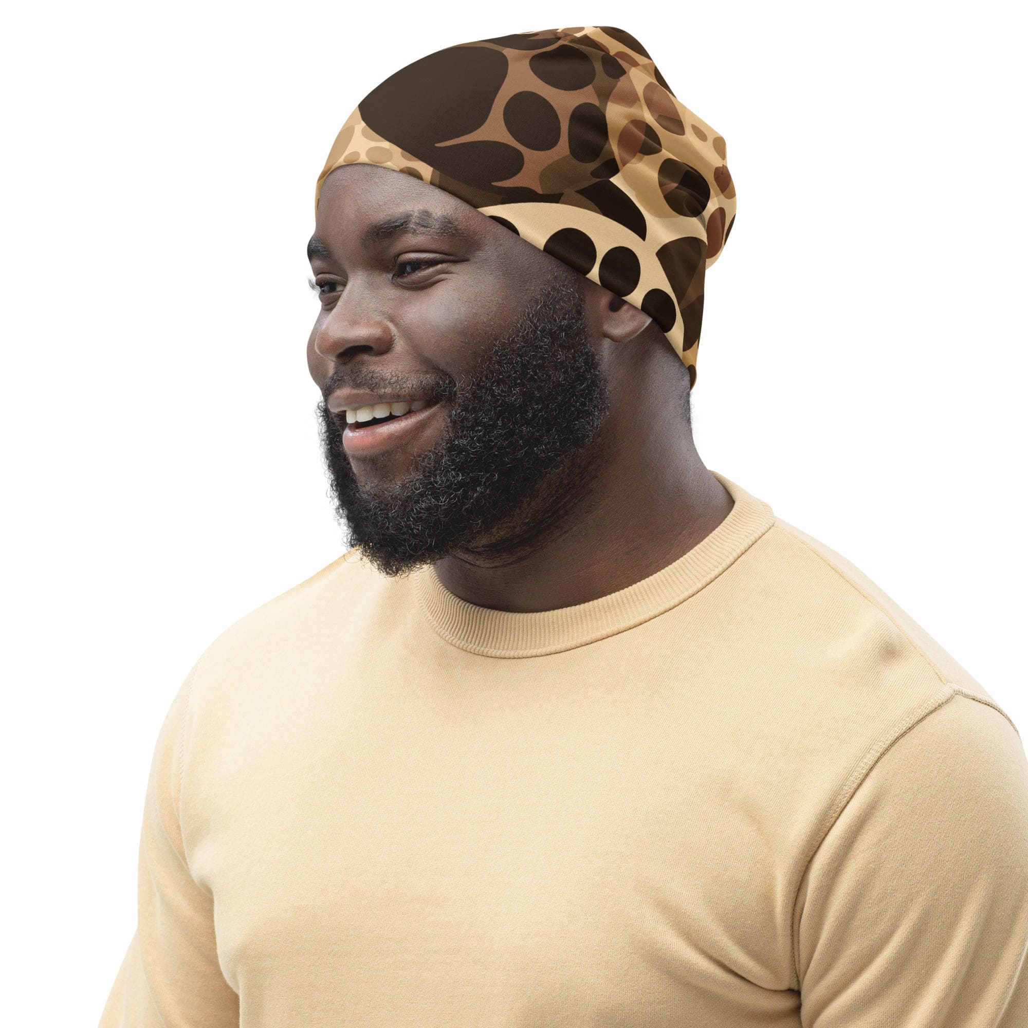 Double-layered beanie hat in beige and brown spotted print, showcasing its soft fabric and stylish design.