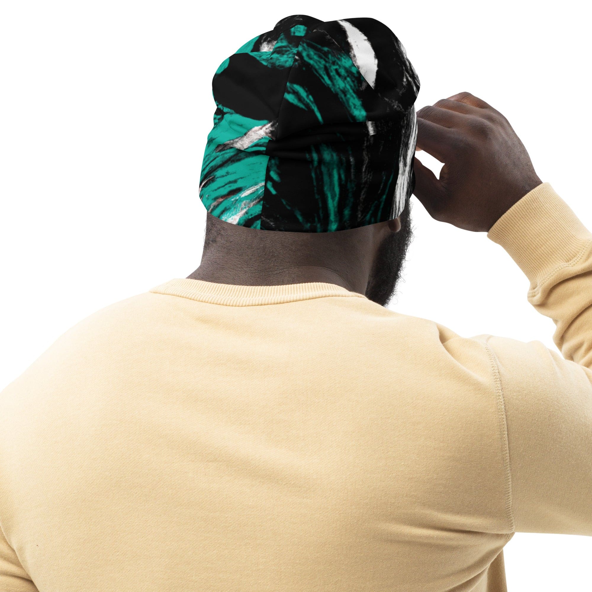 Double-layered beanie hat featuring a black, green, and white abstract pattern, perfect for winter and stylish outfits.