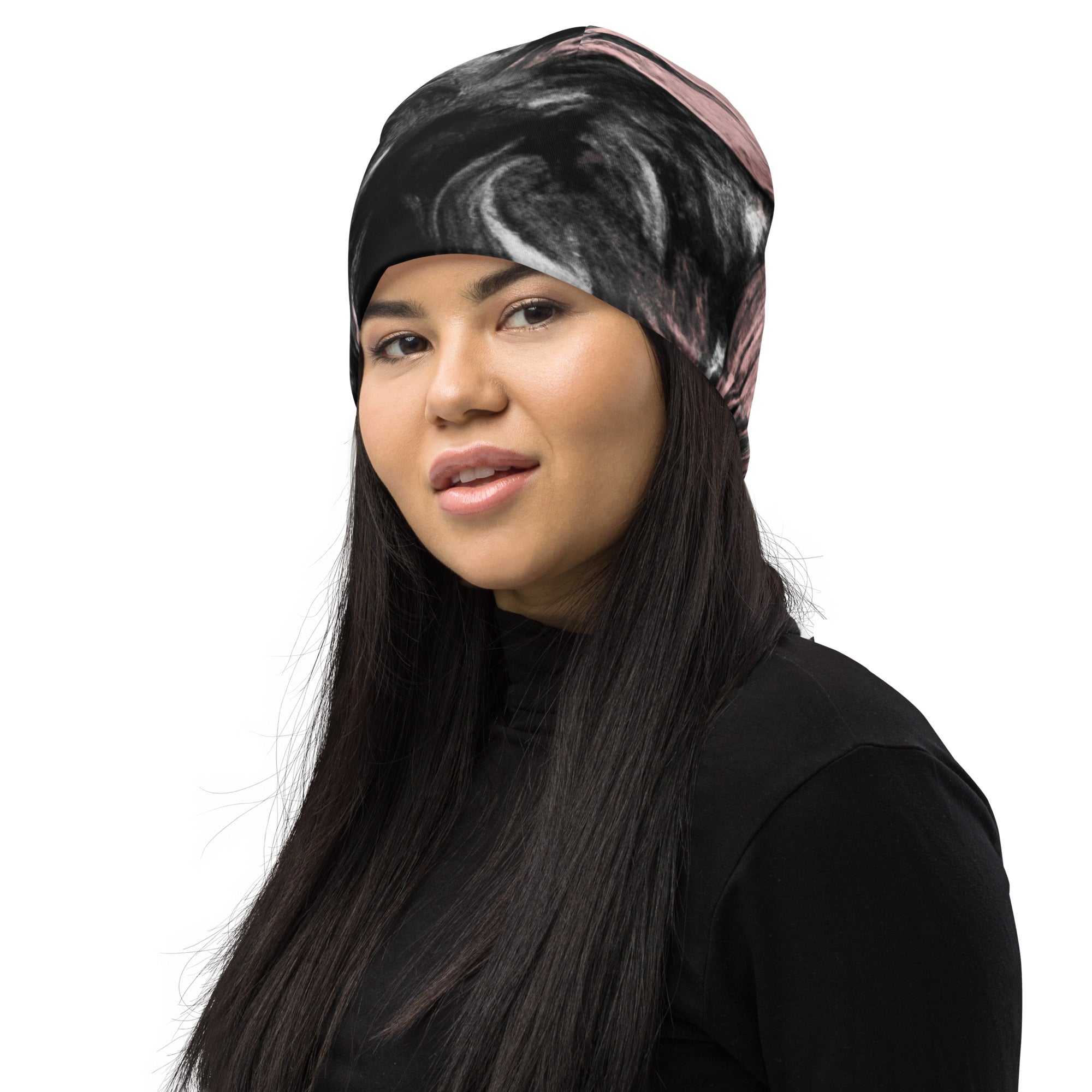 Double-layered beanie hat in black, pink, and white abstract pattern, showcasing its stylish design and soft fabric.