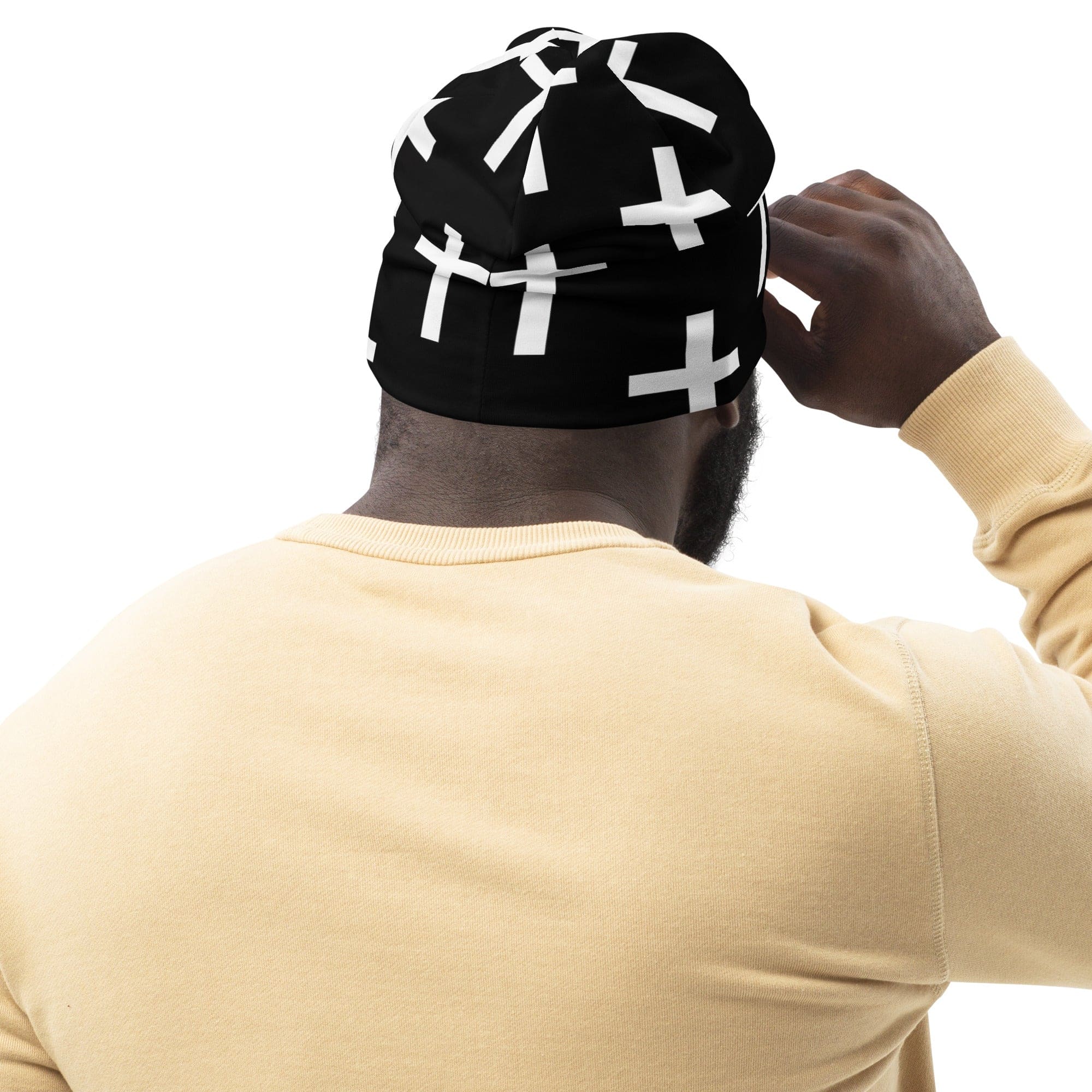 Double-layered beanie hat in black and white cross print, showcasing its soft fabric and stylish design.