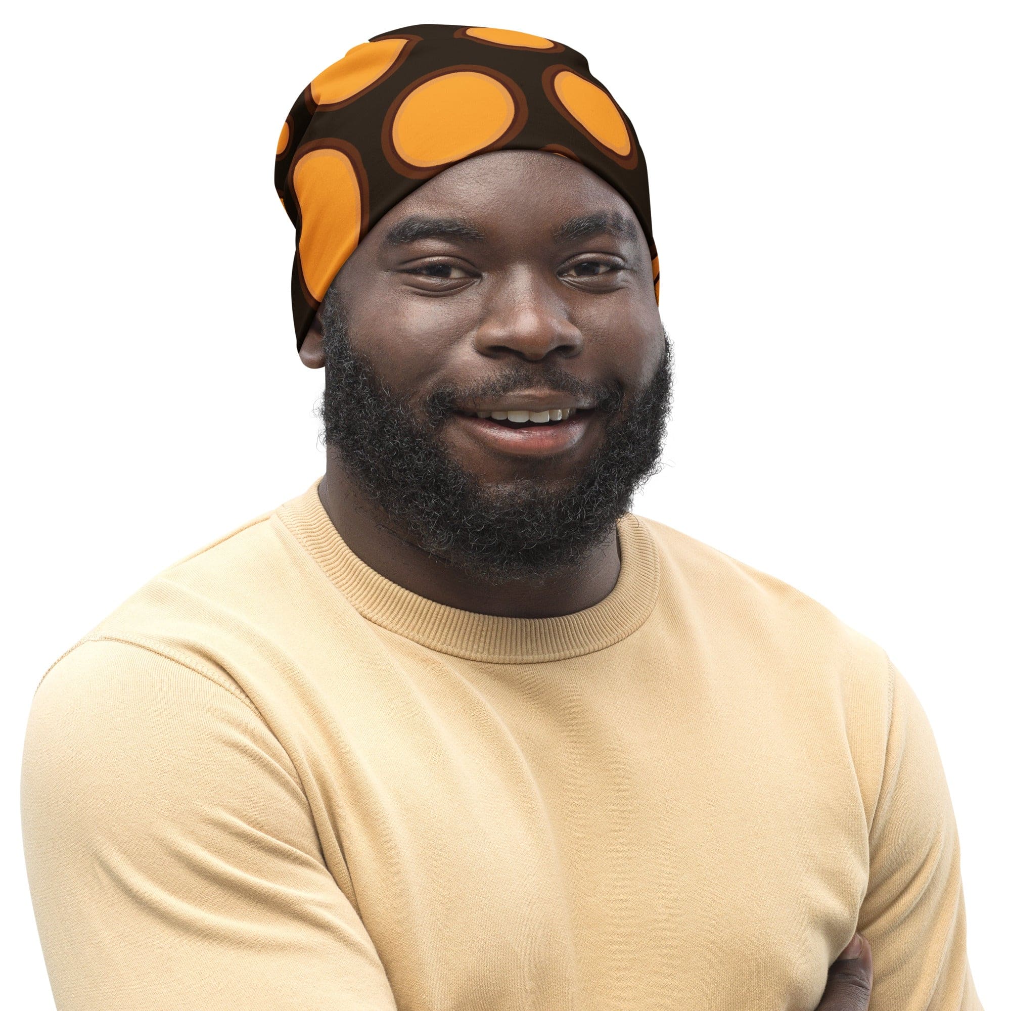 Double-layered beanie hat in orange and brown spotted print, showcasing its soft fabric and stylish design.