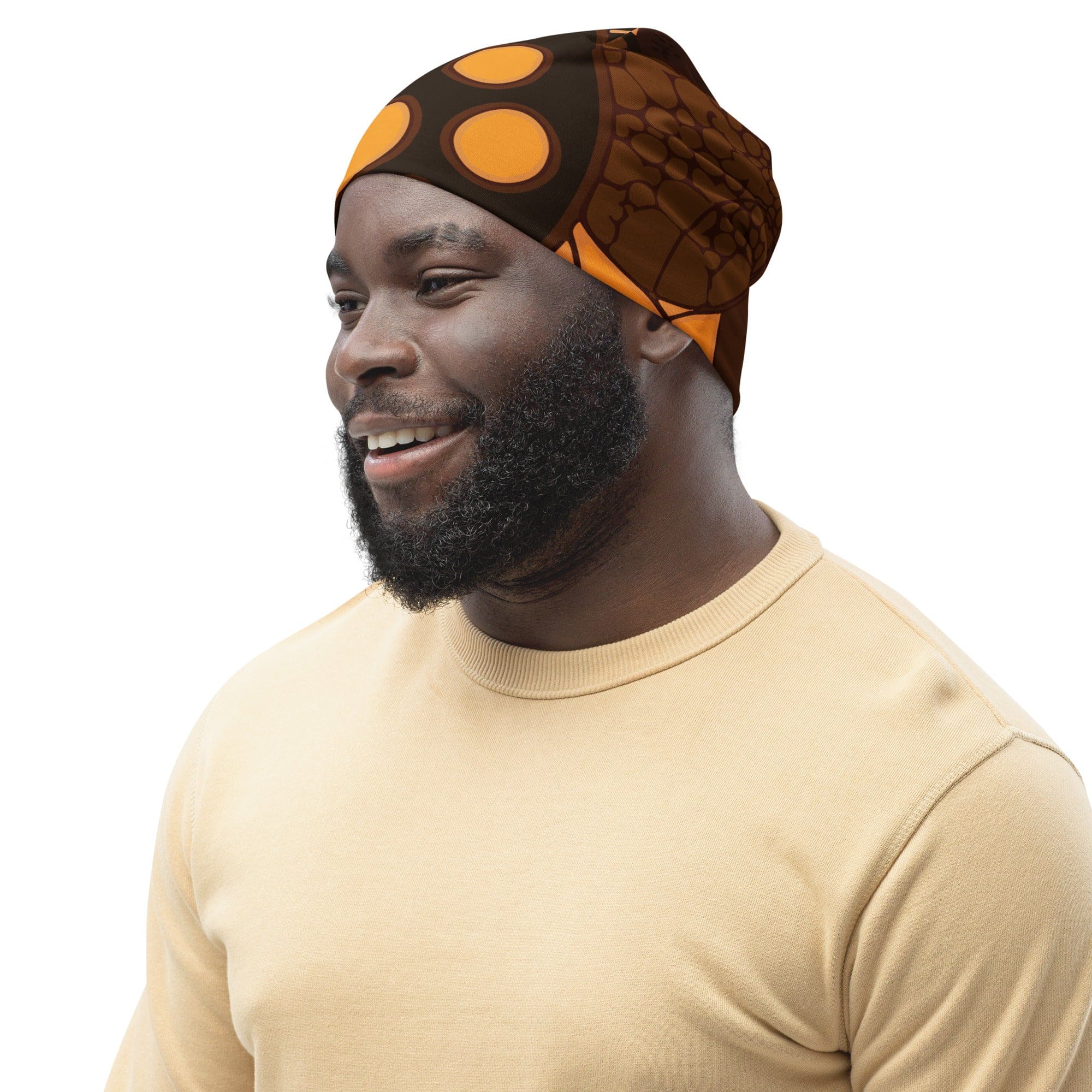 Double-layered beanie hat in orange and brown spotted print, showcasing its soft fabric and stylish design.