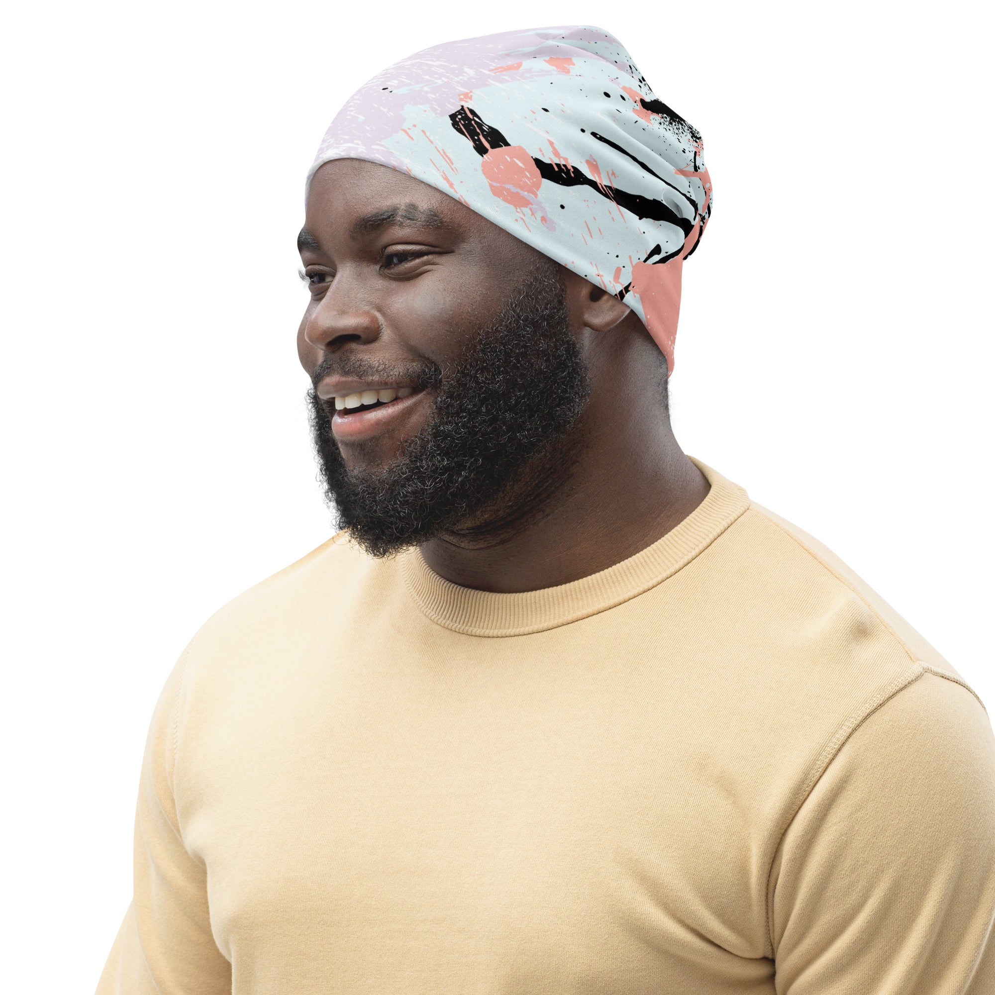 Double-layered beanie hat featuring a pink and black abstract print, designed for warmth and style.