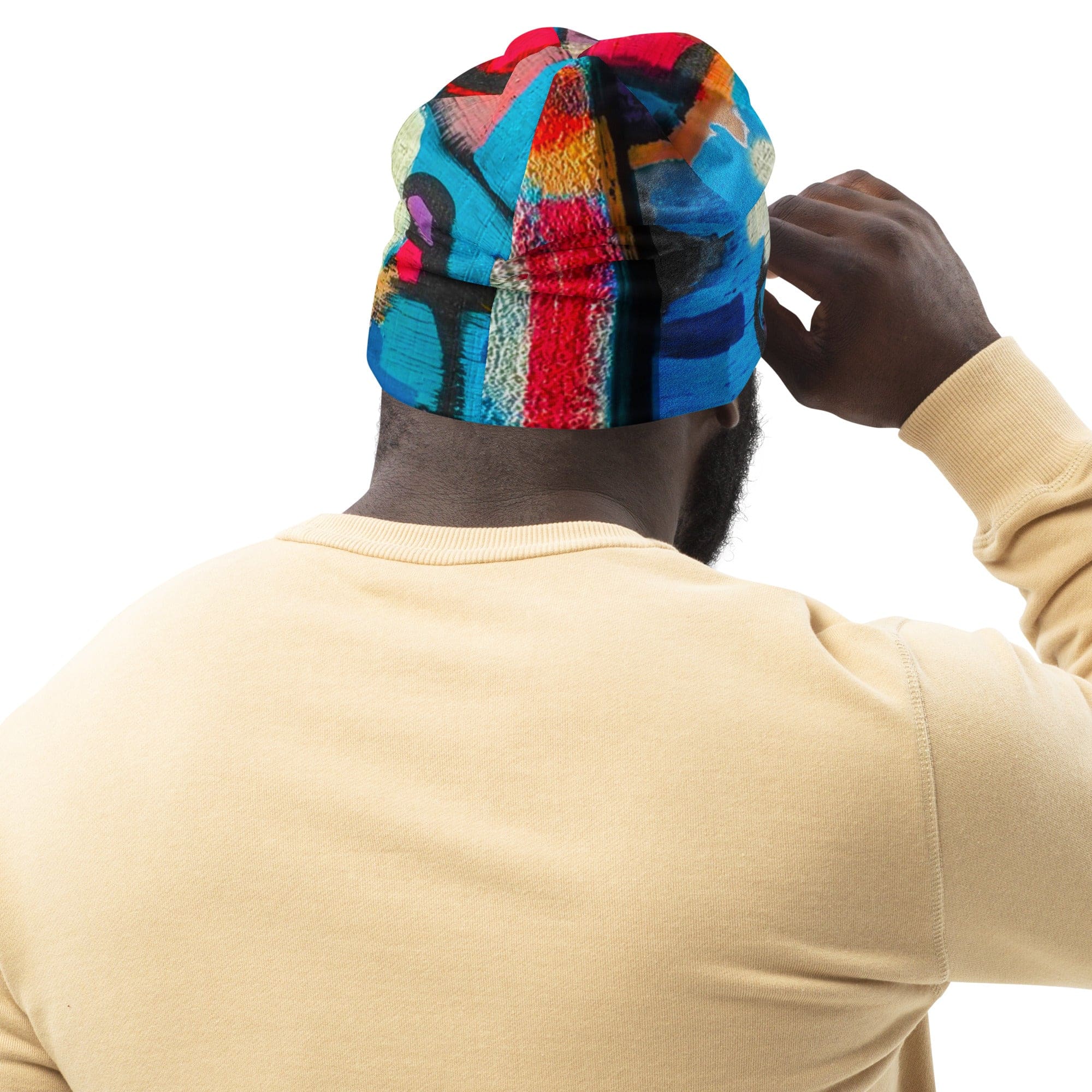 Double-layered beanie hat in red multicolor abstract print, showcasing its soft fabric and stylish design.