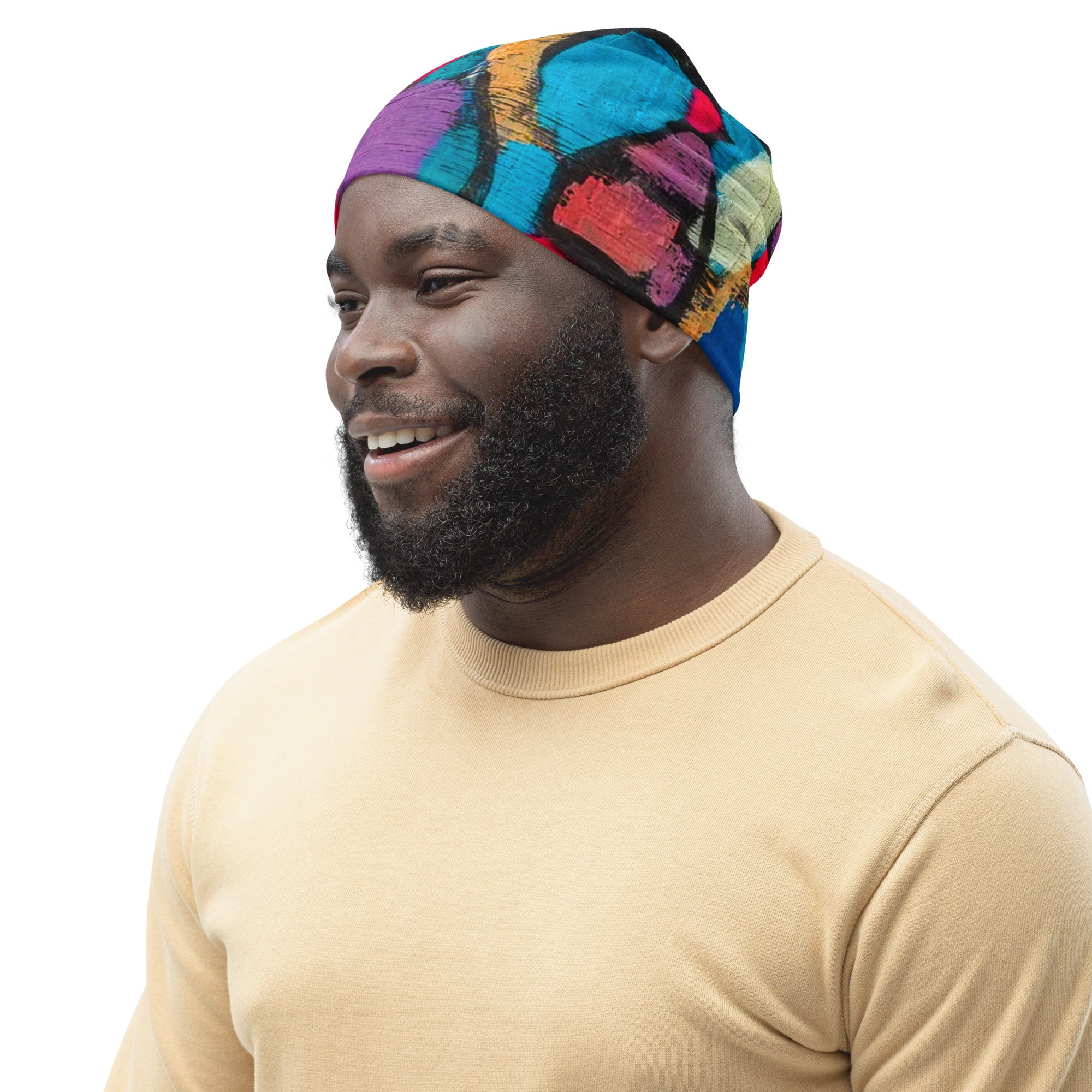 Double-layered beanie hat in red multicolor abstract print, showcasing its soft fabric and stylish design.