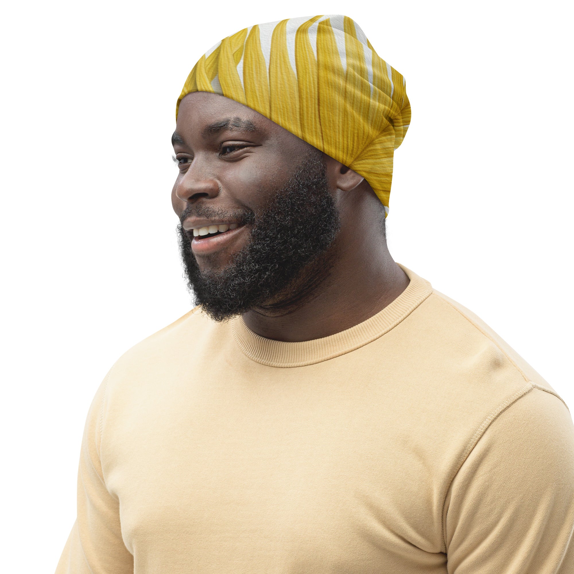 Double-layered beanie hat in yellow with palm leaves pattern, showcasing its soft fabric and stylish design.