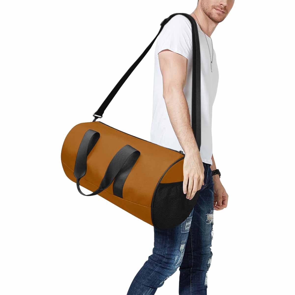 Brown travel duffel bag made from waterproof fabric, featuring a spacious main compartment and adjustable shoulder strap.