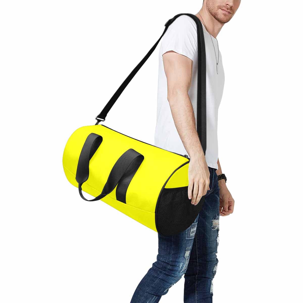 A vibrant yellow duffel bag made from waterproof fabric, featuring a spacious main compartment and side mesh pockets, ideal for travel and outdoor activities.