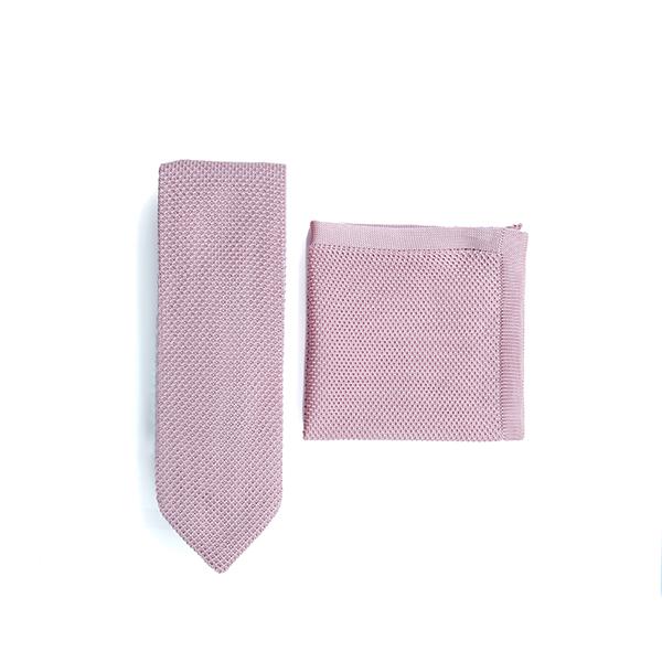 Dusty pink knitted tie and pocket square set displayed elegantly, showcasing the texture and color.