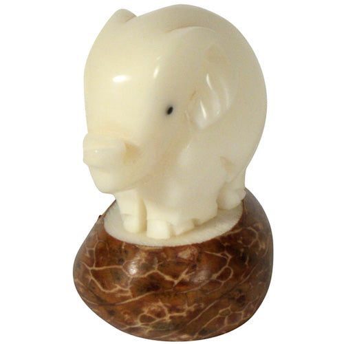 Hand-carved Elephant figurine made from tagua nuts, showcasing natural colors and intricate details, symbolizing eco-friendly craftsmanship.