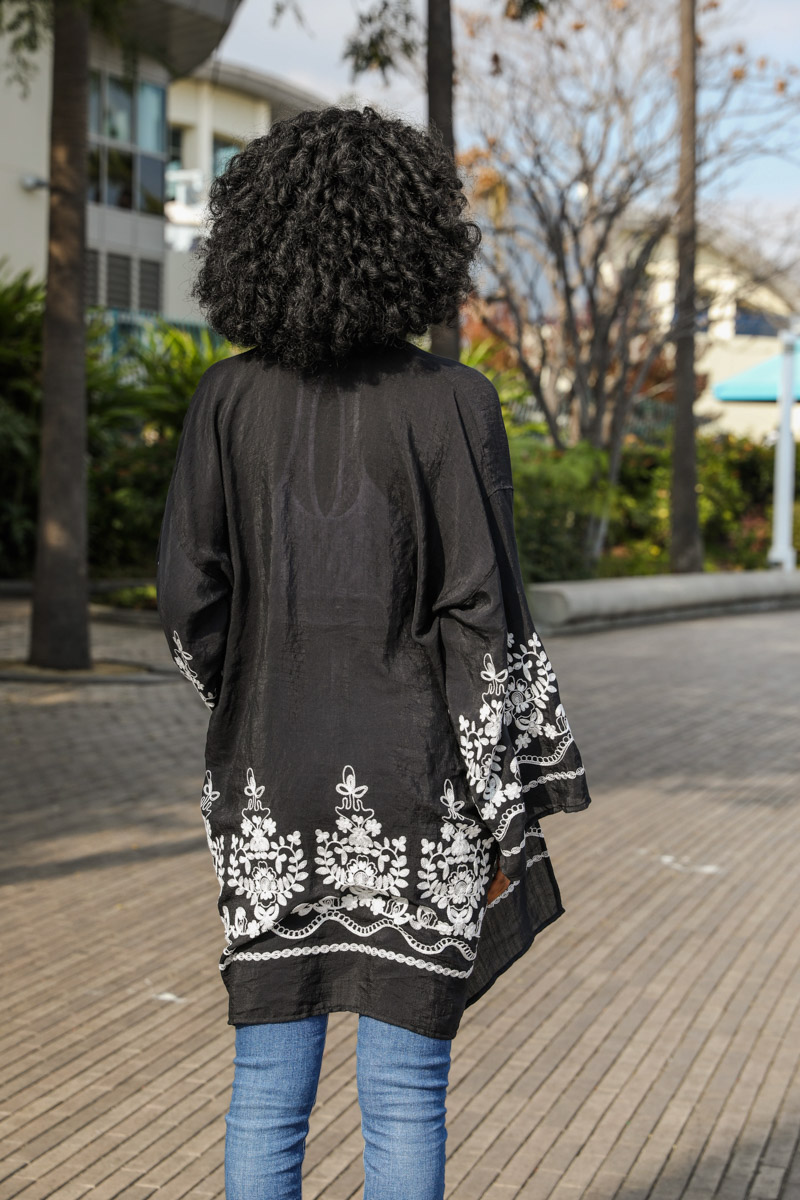 A light and airy embroidered floral vine kimono, showcasing intricate flower designs on a soft fabric, perfect for casual or elegant occasions.