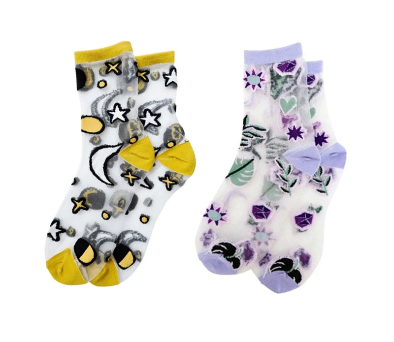 A pair of stylish embroidered mesh ankle socks featuring celestial designs with moons, stars, and botanical motifs in lavender and sunshine yellow trims.