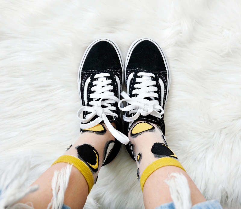 A pair of stylish embroidered mesh ankle socks featuring celestial designs with moons, stars, and botanical motifs in lavender and sunshine yellow trims.