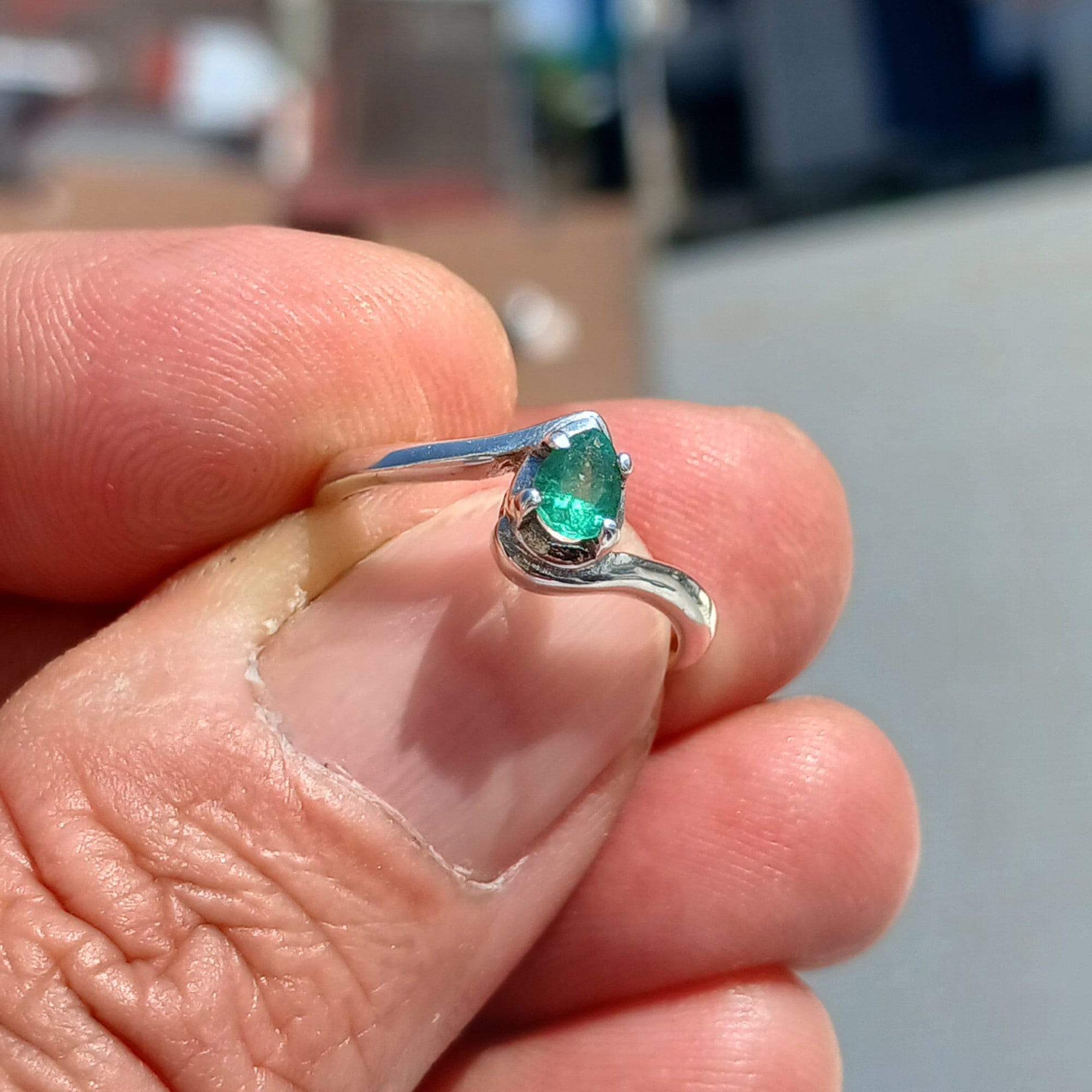 Handmade Sterling Silver Emerald Ring featuring a natural green Pear Shaped Emerald, showcasing its elegant design and craftsmanship.